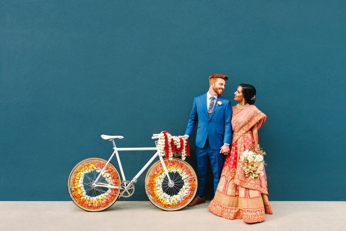 Bride and groom with bicycle Baraat. Two Disney artists create a unique and colorful Indian Fusion wedding at The Fig House Los Angeles, featured on Green Wedding Shoes. | Colorful and elevated wedding inspiration for fun-loving couples in Southern California | #indianwedding #indianfusionwedding #thefighouse #losangeleswedding   Source: Mary Costa Photography | Los Angeles 
