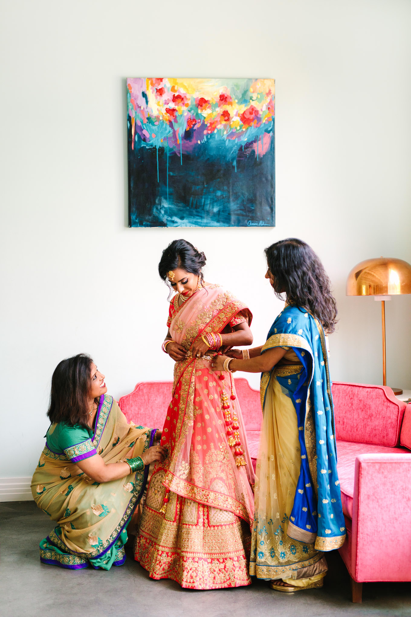 Bride getting dressed. Two Disney artists create a unique and colorful Indian Fusion wedding at The Fig House Los Angeles, featured on Green Wedding Shoes. | Colorful and elevated wedding inspiration for fun-loving couples in Southern California | #indianwedding #indianfusionwedding #thefighouse #losangeleswedding   Source: Mary Costa Photography | Los Angeles