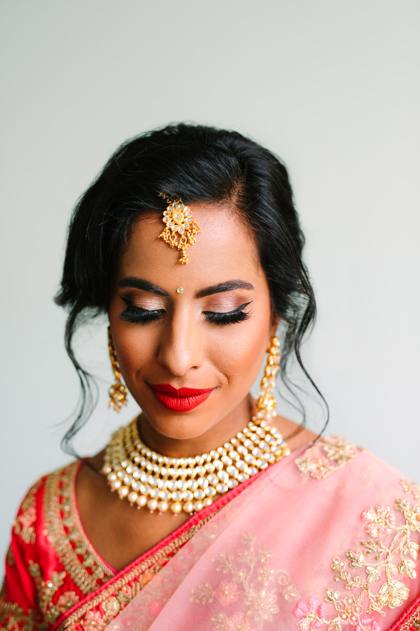Beautiful bride in bright red lipstick. Two Disney artists create a unique and colorful Indian Fusion wedding at The Fig House Los Angeles, featured on Green Wedding Shoes. | Colorful and elevated wedding inspiration for fun-loving couples in Southern California | #indianwedding #indianfusionwedding #thefighouse #losangeleswedding   Source: Mary Costa Photography | Los Angeles