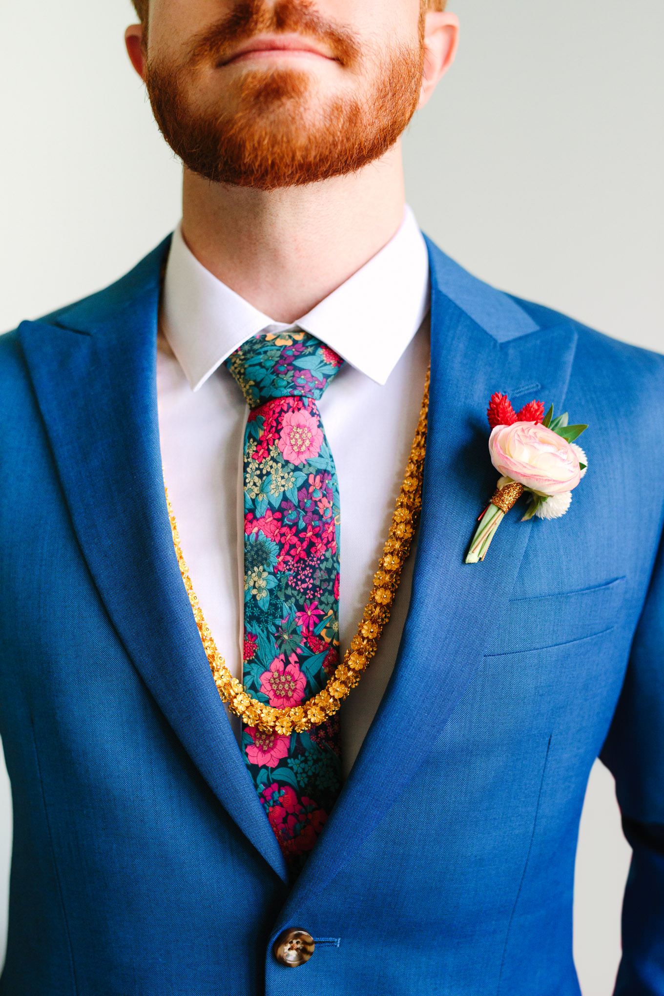 Groom detail of OTAA colorful floral tie. Two Disney artists create a unique and colorful Indian Fusion wedding at The Fig House Los Angeles, featured on Green Wedding Shoes. | Colorful and elevated wedding inspiration for fun-loving couples in Southern California | #indianwedding #indianfusionwedding #thefighouse #losangeleswedding   Source: Mary Costa Photography | Los Angeles