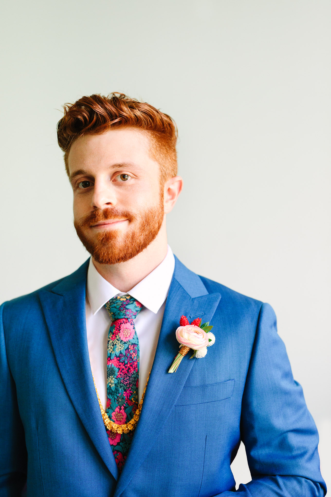Groom with red hair in bright blue suit with OTAA tie. Two Disney artists create a unique and colorful Indian Fusion wedding at The Fig House Los Angeles, featured on Green Wedding Shoes. | Colorful and elevated wedding inspiration for fun-loving couples in Southern California | #indianwedding #indianfusionwedding #thefighouse #losangeleswedding   Source: Mary Costa Photography | Los Angeles