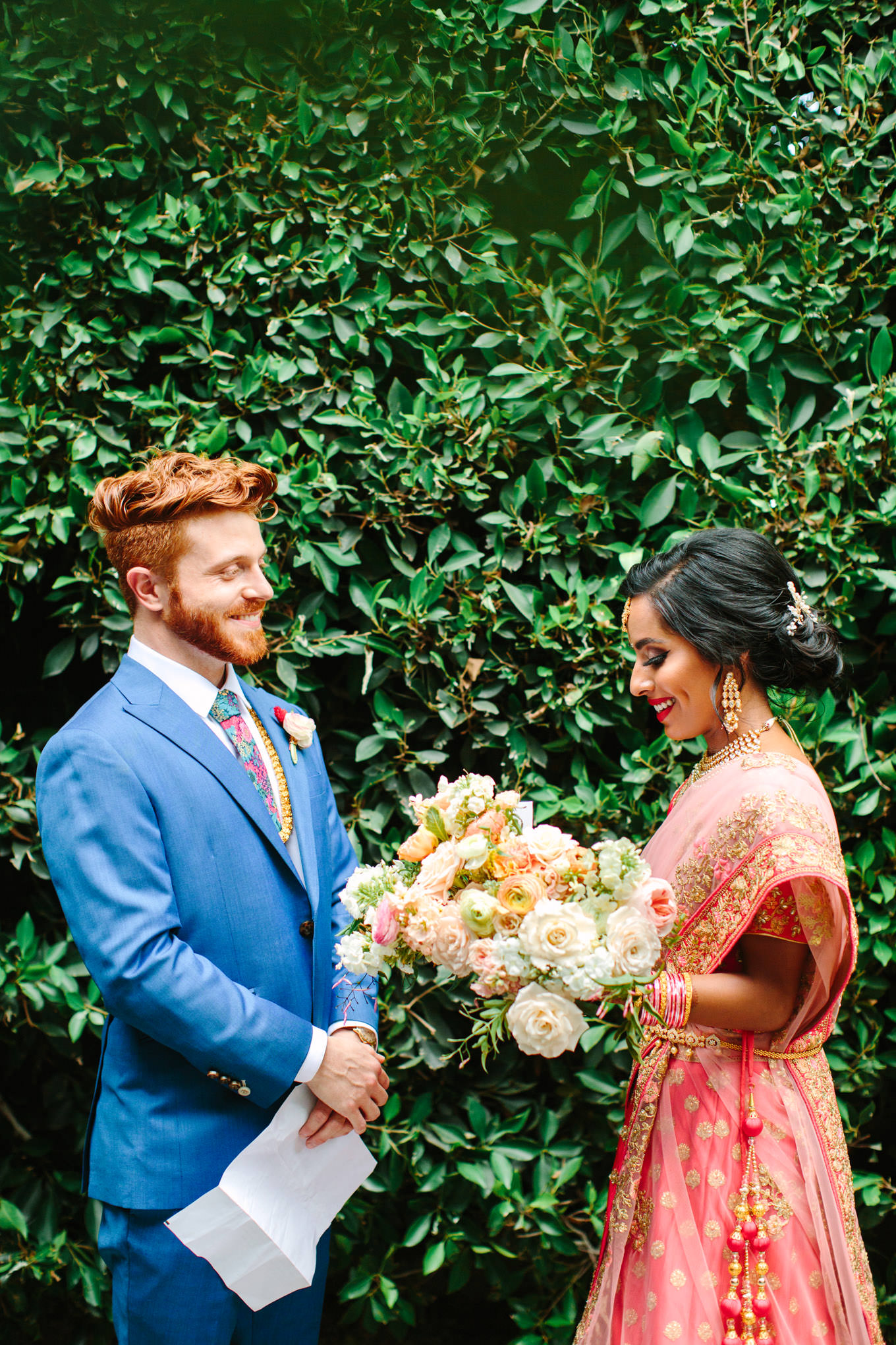 Bride and groom exchange vows privately before public ceremony. Two Disney artists create a unique and colorful Indian Fusion wedding at The Fig House Los Angeles, featured on Green Wedding Shoes. | Colorful and elevated wedding inspiration for fun-loving couples in Southern California | #indianwedding #indianfusionwedding #thefighouse #losangeleswedding   Source: Mary Costa Photography | Los Angeles