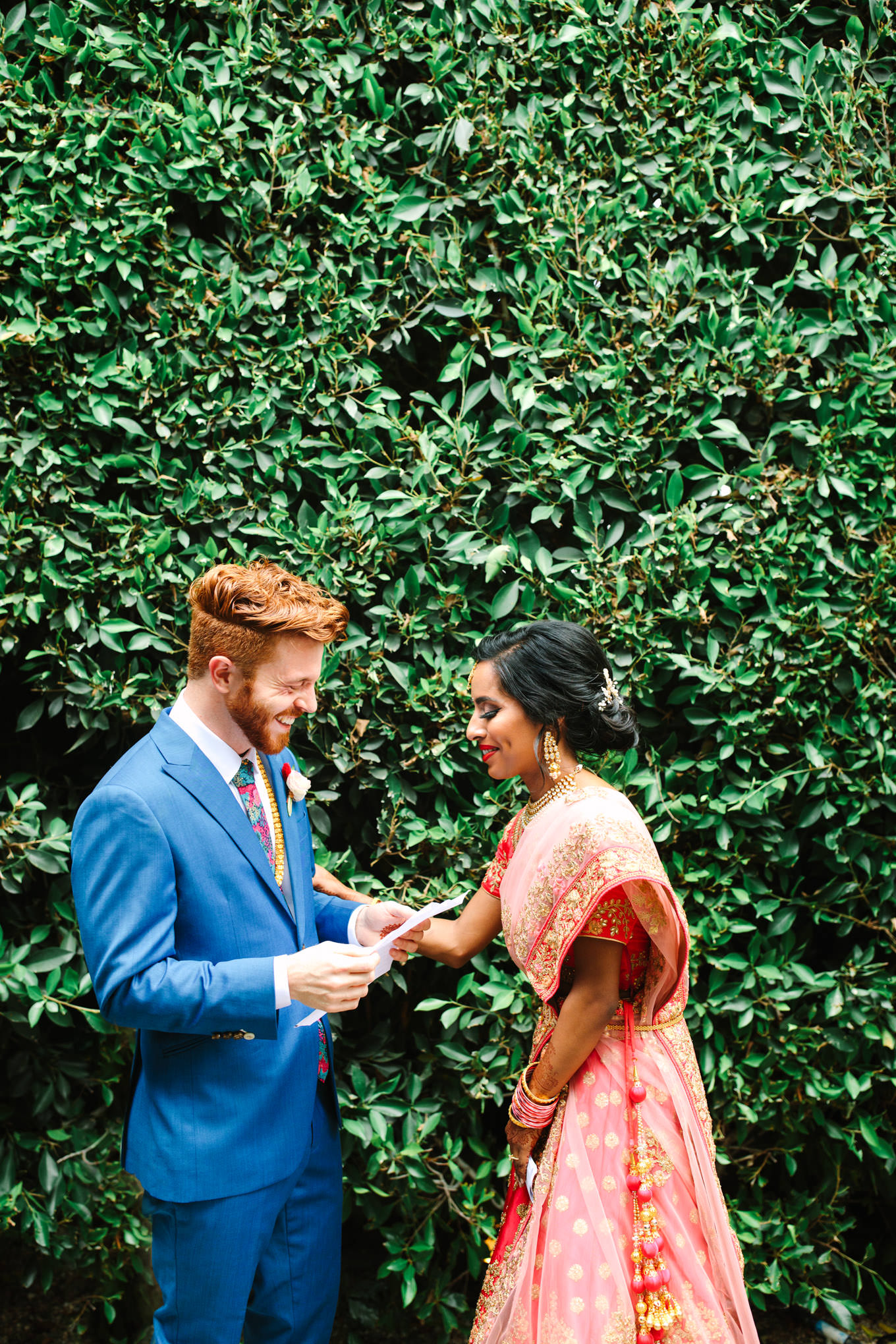 Bride and groom exchange vows privately before public ceremony. Two Disney artists create a unique and colorful Indian Fusion wedding at The Fig House Los Angeles, featured on Green Wedding Shoes. | Colorful and elevated wedding inspiration for fun-loving couples in Southern California | #indianwedding #indianfusionwedding #thefighouse #losangeleswedding   Source: Mary Costa Photography | Los Angeles