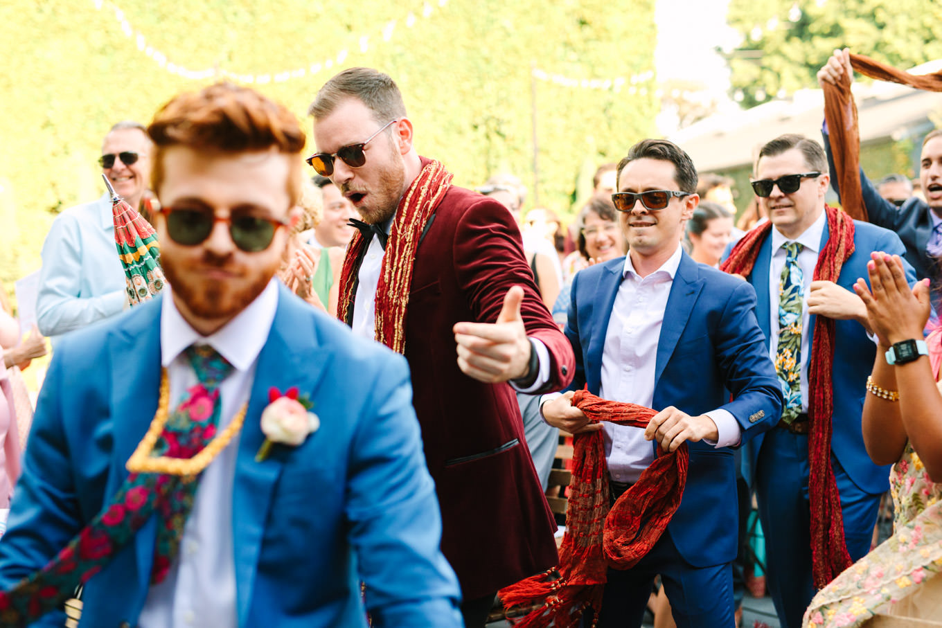 Groom and groomsmen entering wedding ceremony. Two Disney artists create a unique and colorful Indian Fusion wedding at The Fig House Los Angeles, featured on Green Wedding Shoes. | Colorful and elevated wedding inspiration for fun-loving couples in Southern California | #indianwedding #indianfusionwedding #thefighouse #losangeleswedding   Source: Mary Costa Photography | Los Angeles