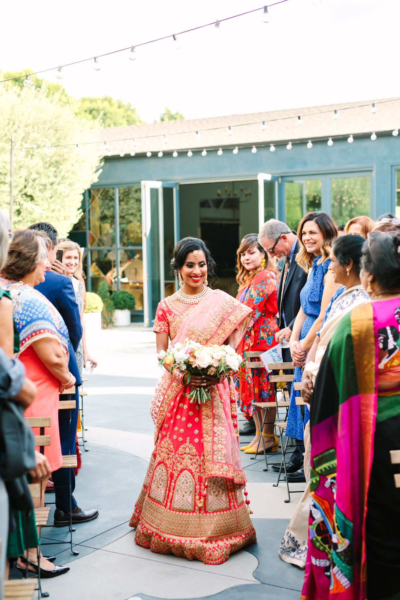 Bride walking down the aisle during wedding ceremony. Two Disney artists create a unique and colorful Indian Fusion wedding at The Fig House Los Angeles, featured on Green Wedding Shoes. | Colorful and elevated wedding inspiration for fun-loving couples in Southern California | #indianwedding #indianfusionwedding #thefighouse #losangeleswedding   Source: Mary Costa Photography | Los Angeles