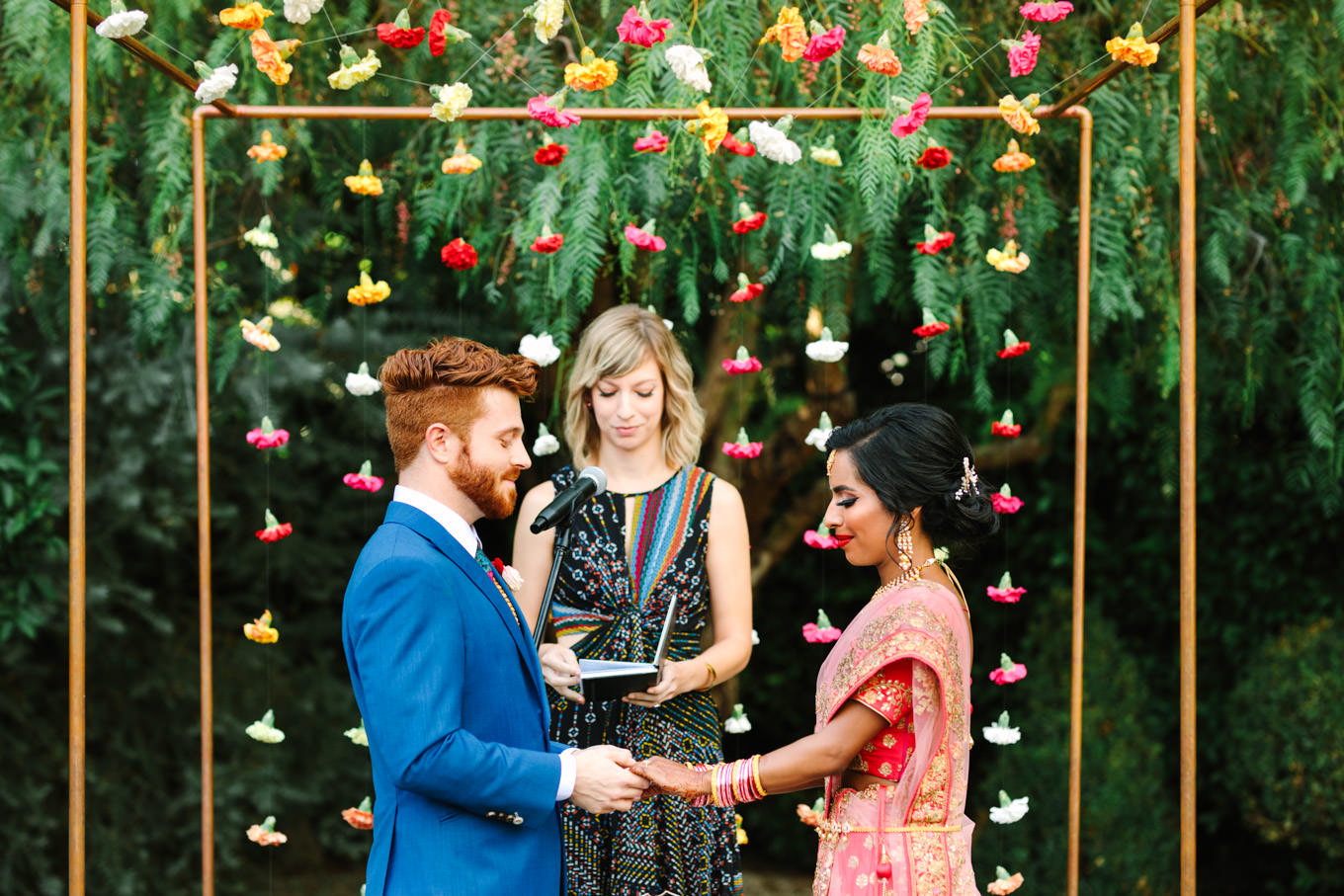 Bride and groom during wedding ceremony. Two Disney artists create a unique and colorful Indian Fusion wedding at The Fig House Los Angeles, featured on Green Wedding Shoes. | Colorful and elevated wedding inspiration for fun-loving couples in Southern California | #indianwedding #indianfusionwedding #thefighouse #losangeleswedding   Source: Mary Costa Photography | Los Angeles