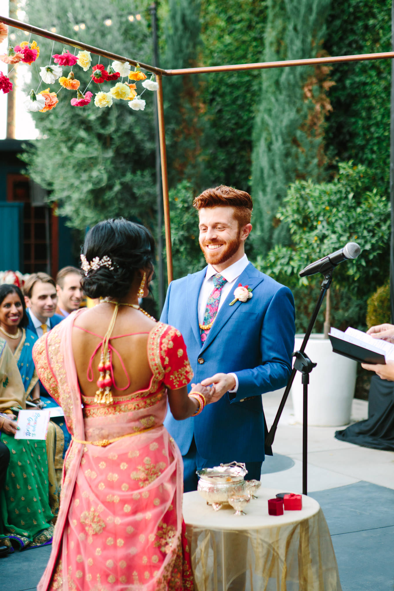 Bride and groom during wedding ceremony. Two Disney artists create a unique and colorful Indian Fusion wedding at The Fig House Los Angeles, featured on Green Wedding Shoes. | Colorful and elevated wedding inspiration for fun-loving couples in Southern California | #indianwedding #indianfusionwedding #thefighouse #losangeleswedding   Source: Mary Costa Photography | Los Angeles