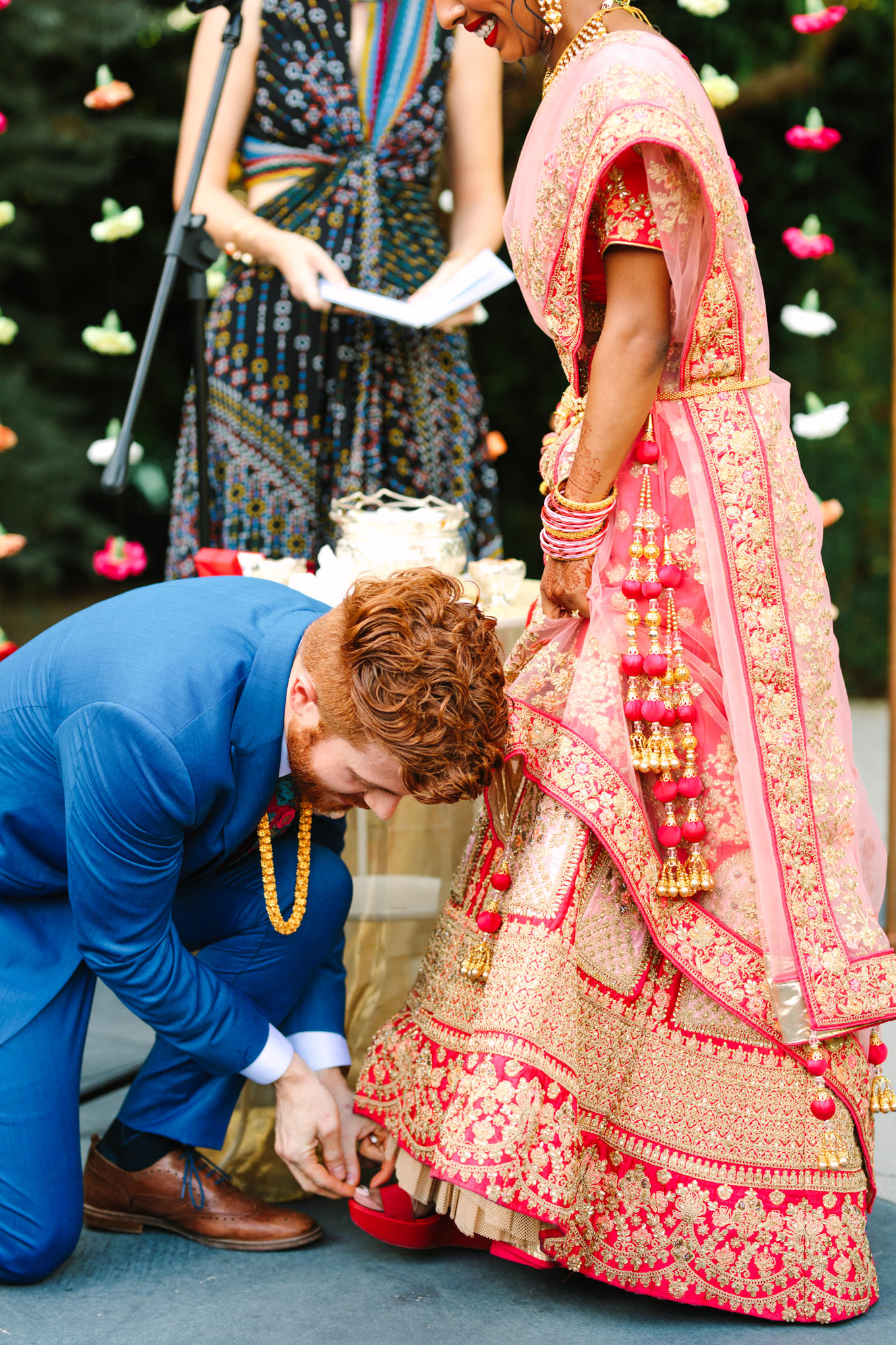Groom placing toe ring on bride. Two Disney artists create a unique and colorful Indian Fusion wedding at The Fig House Los Angeles, featured on Green Wedding Shoes. | Colorful and elevated wedding inspiration for fun-loving couples in Southern California | #indianwedding #indianfusionwedding #thefighouse #losangeleswedding   Source: Mary Costa Photography | Los Angeles