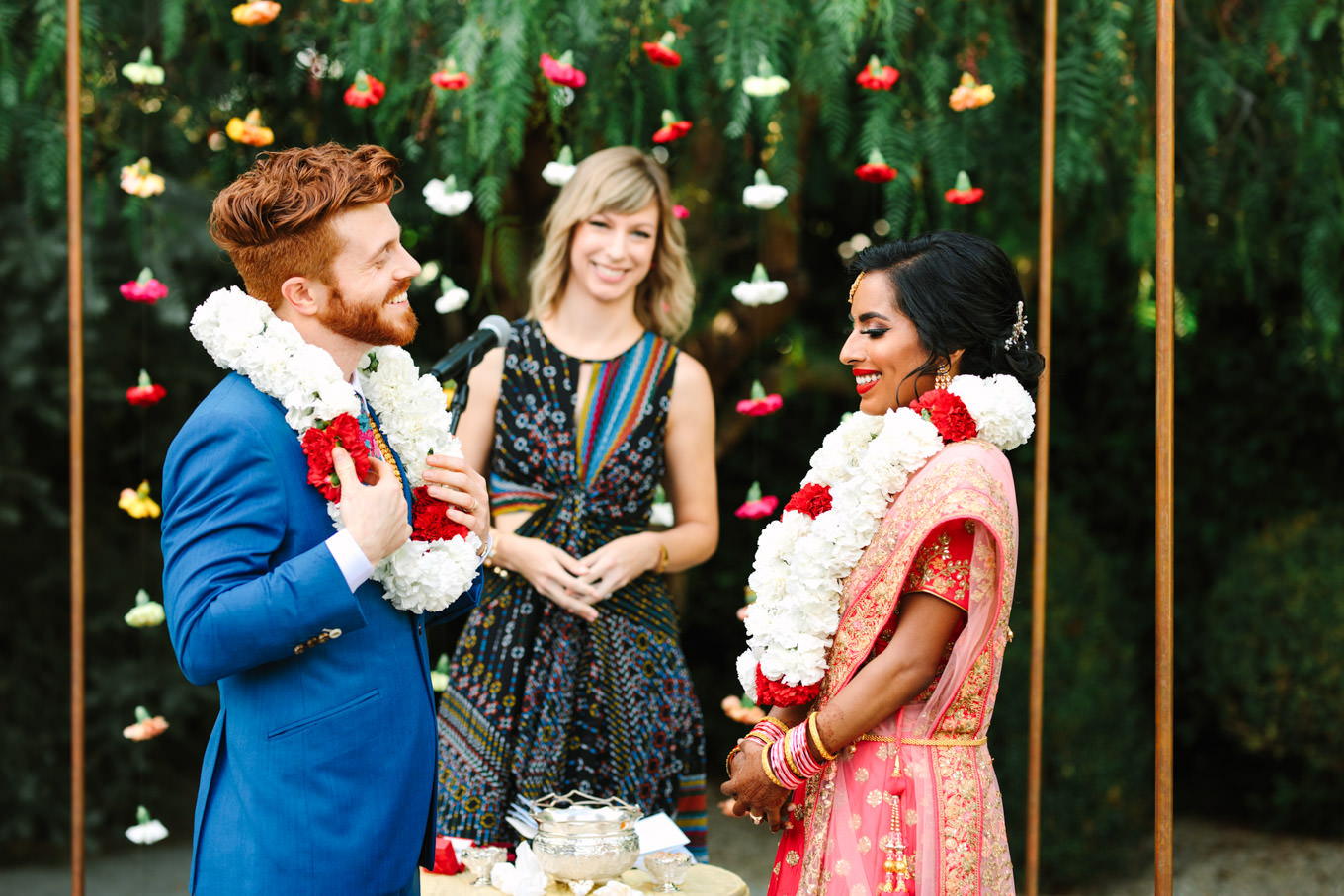 Bride and groom wearing flower Mala. Two Disney artists create a unique and colorful Indian Fusion wedding at The Fig House Los Angeles, featured on Green Wedding Shoes. | Colorful and elevated wedding inspiration for fun-loving couples in Southern California | #indianwedding #indianfusionwedding #thefighouse #losangeleswedding   Source: Mary Costa Photography | Los Angeles