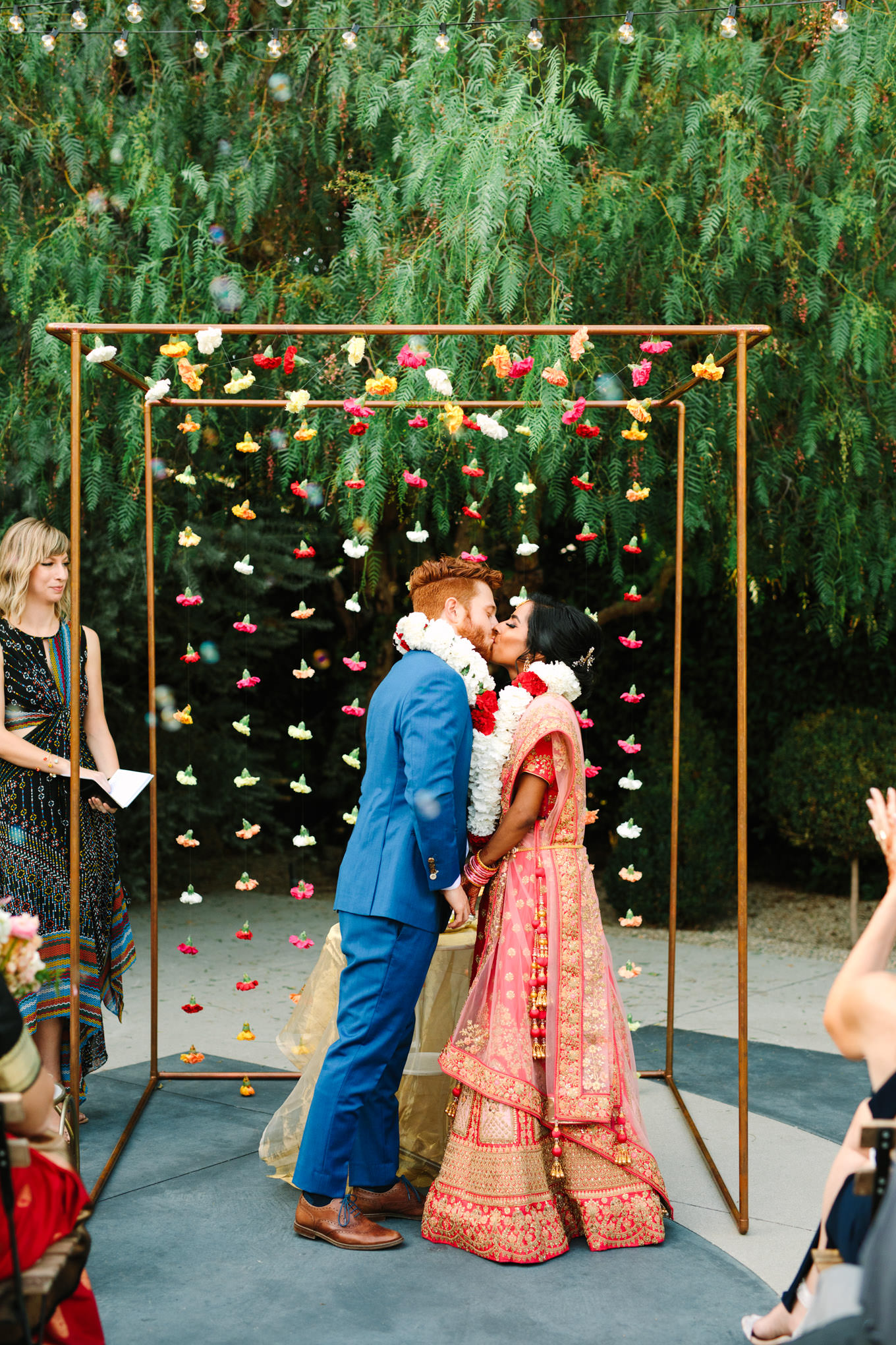 Wedding ceremony kiss. Two Disney artists create a unique and colorful Indian Fusion wedding at The Fig House Los Angeles, featured on Green Wedding Shoes. | Colorful and elevated wedding inspiration for fun-loving couples in Southern California | #indianwedding #indianfusionwedding #thefighouse #losangeleswedding   Source: Mary Costa Photography | Los Angeles