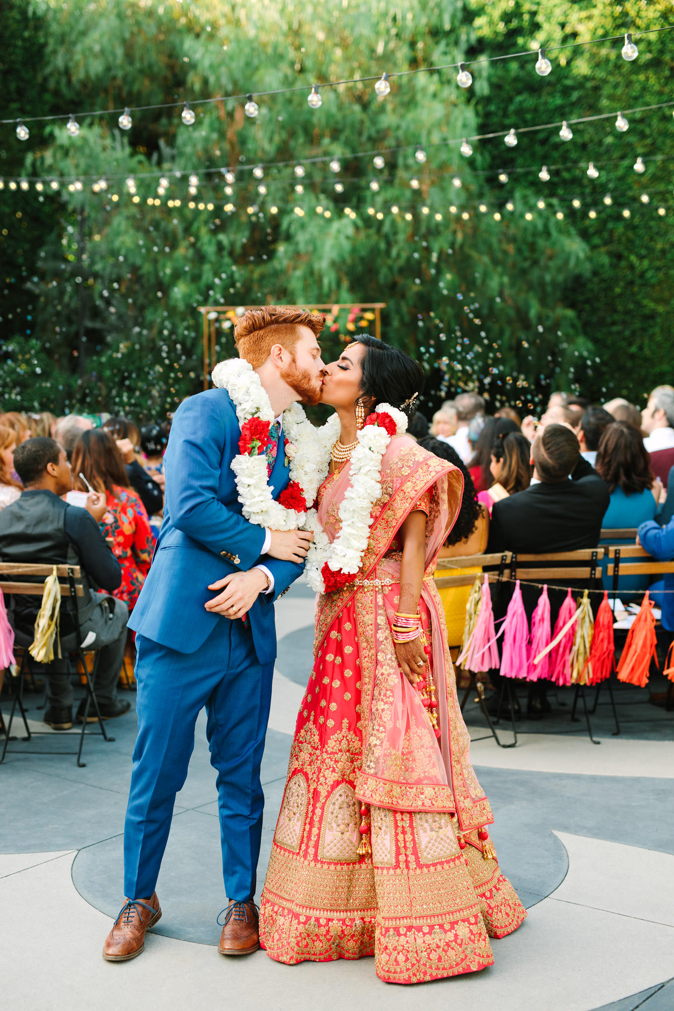 Bride and groom kissing with bubbles. Two Disney artists create a unique and colorful Indian Fusion wedding at The Fig House Los Angeles, featured on Green Wedding Shoes. | Colorful and elevated wedding inspiration for fun-loving couples in Southern California | #indianwedding #indianfusionwedding #thefighouse #losangeleswedding   Source: Mary Costa Photography | Los Angeles