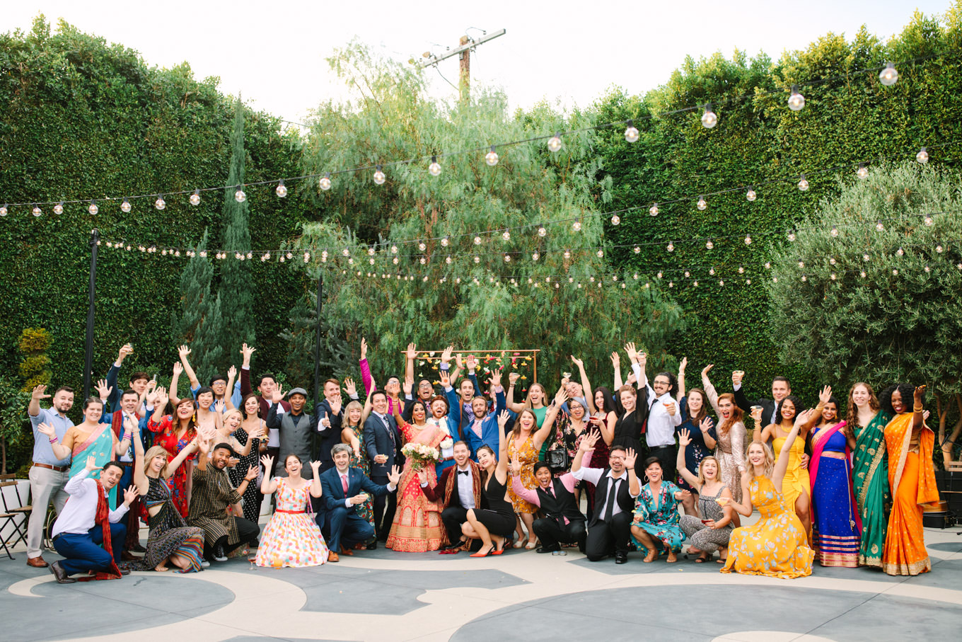 Large group photograph. Two Disney artists create a unique and colorful Indian Fusion wedding at The Fig House Los Angeles, featured on Green Wedding Shoes. | Colorful and elevated wedding inspiration for fun-loving couples in Southern California | #indianwedding #indianfusionwedding #thefighouse #losangeleswedding   Source: Mary Costa Photography | Los Angeles