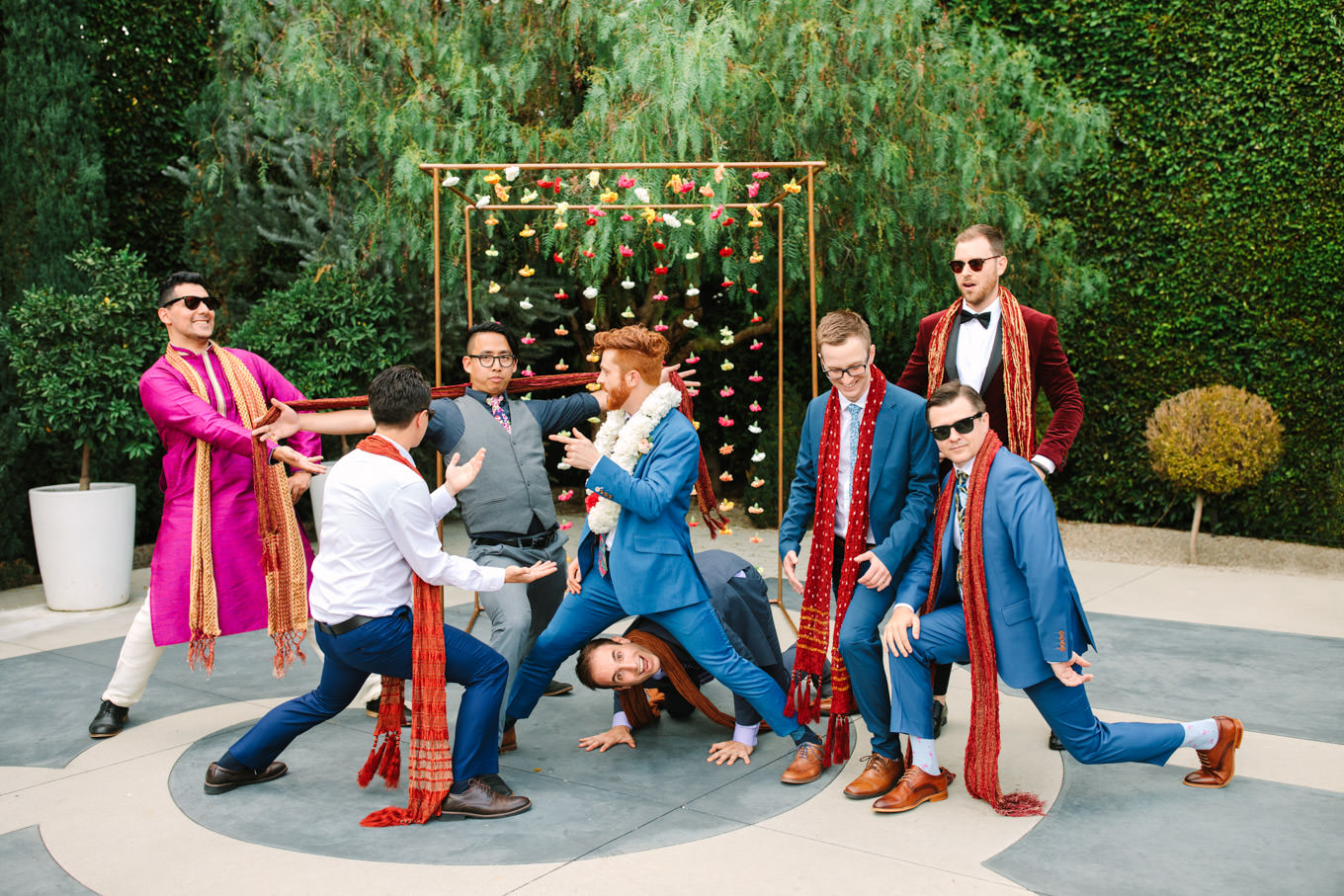 Playful photo of groom with groomsmen. Two Disney artists create a unique and colorful Indian Fusion wedding at The Fig House Los Angeles, featured on Green Wedding Shoes. | Colorful and elevated wedding inspiration for fun-loving couples in Southern California | #indianwedding #indianfusionwedding #thefighouse #losangeleswedding   Source: Mary Costa Photography | Los Angeles