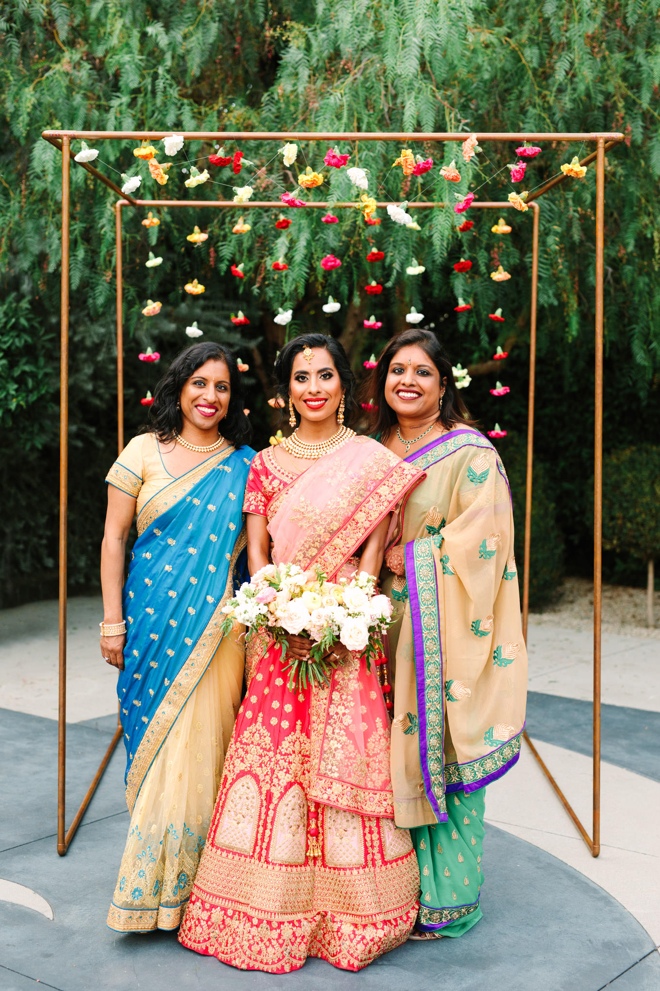 Bride and sisters in colorful saree gowns. Two Disney artists create a unique and colorful Indian Fusion wedding at The Fig House Los Angeles, featured on Green Wedding Shoes. | Colorful and elevated wedding inspiration for fun-loving couples in Southern California | #indianwedding #indianfusionwedding #thefighouse #losangeleswedding   Source: Mary Costa Photography | Los Angeles