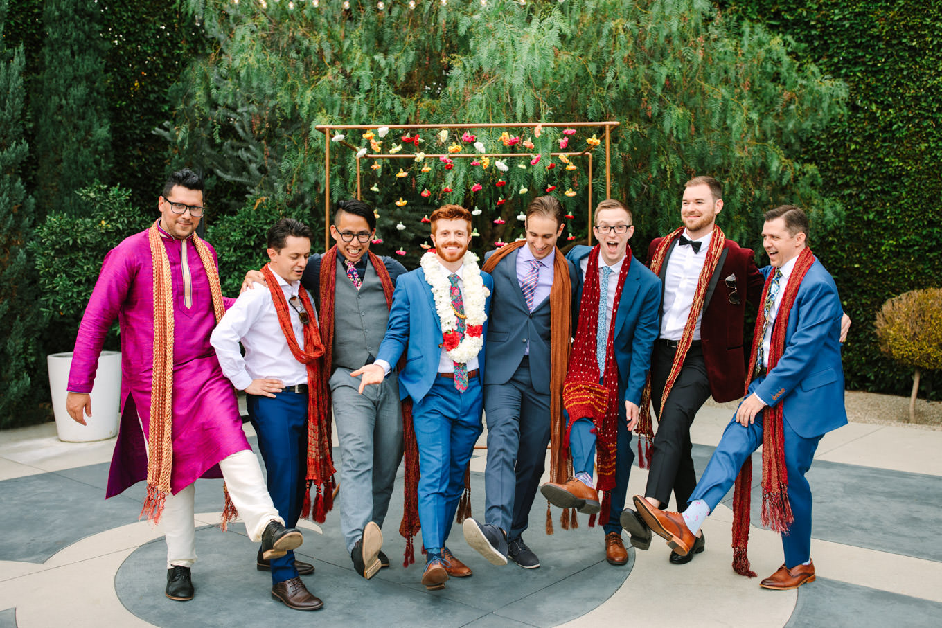 Groom and groomsmen showing off eclectic socks. Two Disney artists create a unique and colorful Indian Fusion wedding at The Fig House Los Angeles, featured on Green Wedding Shoes. | Colorful and elevated wedding inspiration for fun-loving couples in Southern California | #indianwedding #indianfusionwedding #thefighouse #losangeleswedding   Source: Mary Costa Photography | Los Angeles