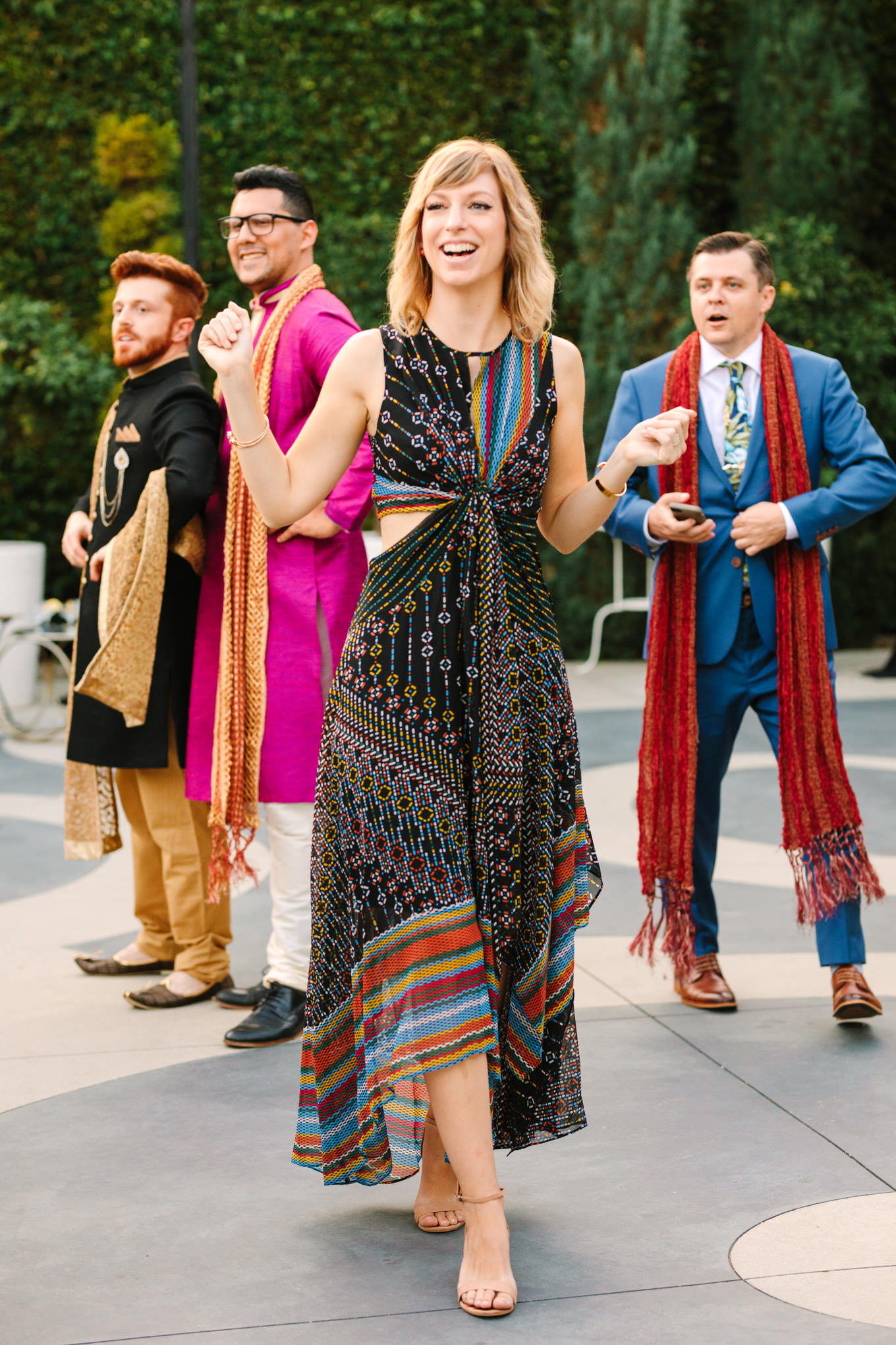 Wedding officiant laughing. Two Disney artists create a unique and colorful Indian Fusion wedding at The Fig House Los Angeles, featured on Green Wedding Shoes. | Colorful and elevated wedding inspiration for fun-loving couples in Southern California | #indianwedding #indianfusionwedding #thefighouse #losangeleswedding   Source: Mary Costa Photography | Los Angeles