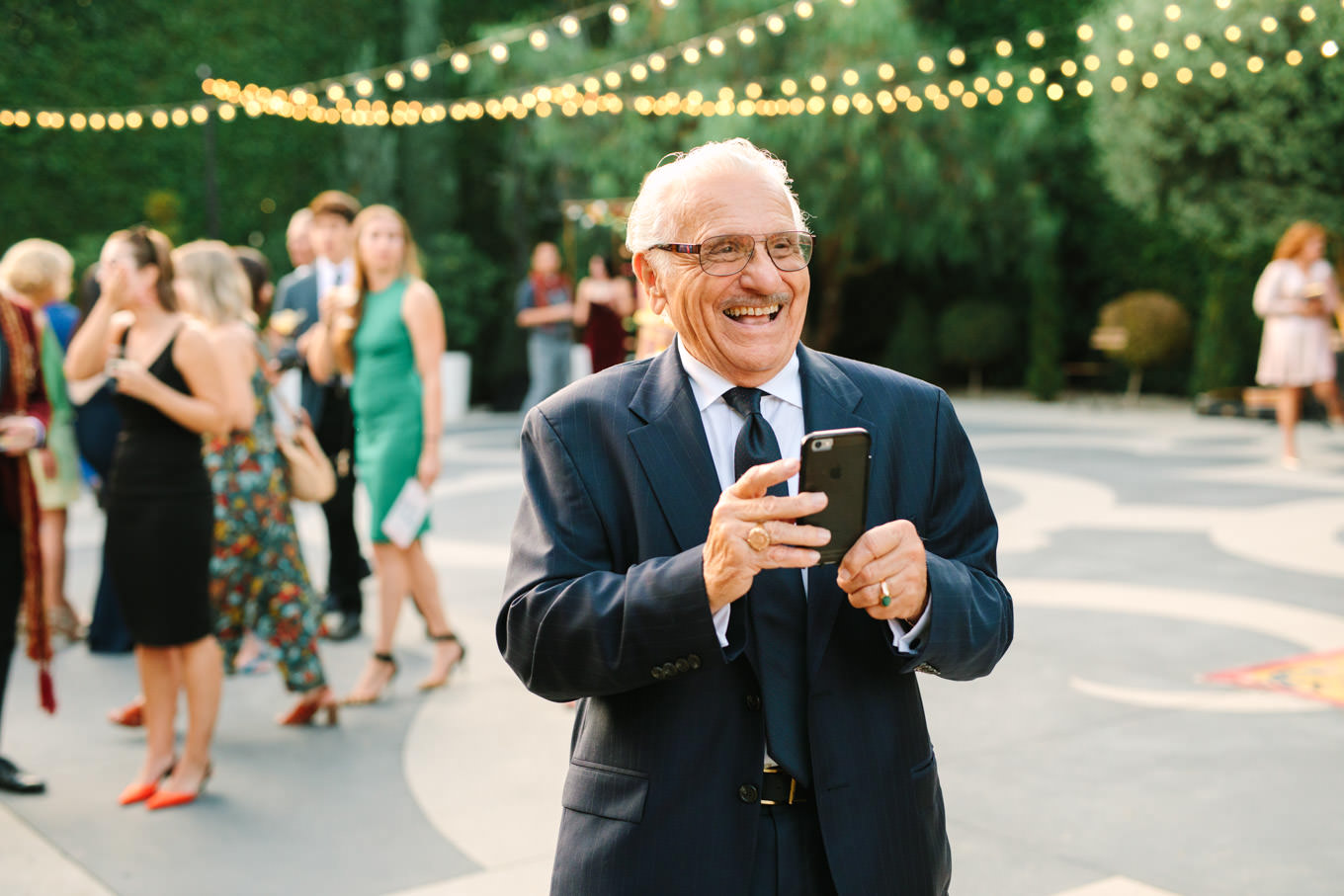 Candid of groom's grandfather laughing. Two Disney artists create a unique and colorful Indian Fusion wedding at The Fig House Los Angeles, featured on Green Wedding Shoes. | Colorful and elevated wedding inspiration for fun-loving couples in Southern California | #indianwedding #indianfusionwedding #thefighouse #losangeleswedding   Source: Mary Costa Photography | Los Angeles