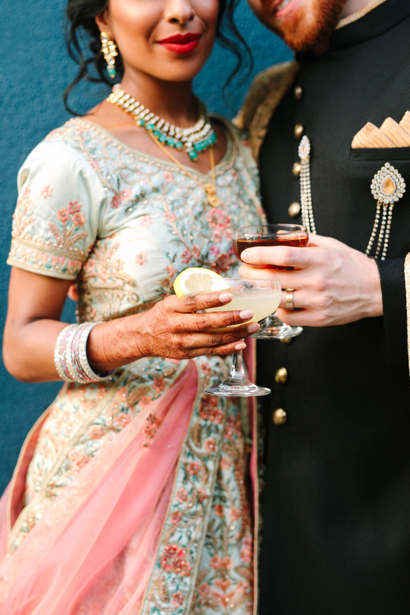 Bride and groom with speciality cocktails. Two Disney artists create a unique and colorful Indian Fusion wedding at The Fig House Los Angeles, featured on Green Wedding Shoes. | Colorful and elevated wedding inspiration for fun-loving couples in Southern California | #indianwedding #indianfusionwedding #thefighouse #losangeleswedding   Source: Mary Costa Photography | Los Angeles