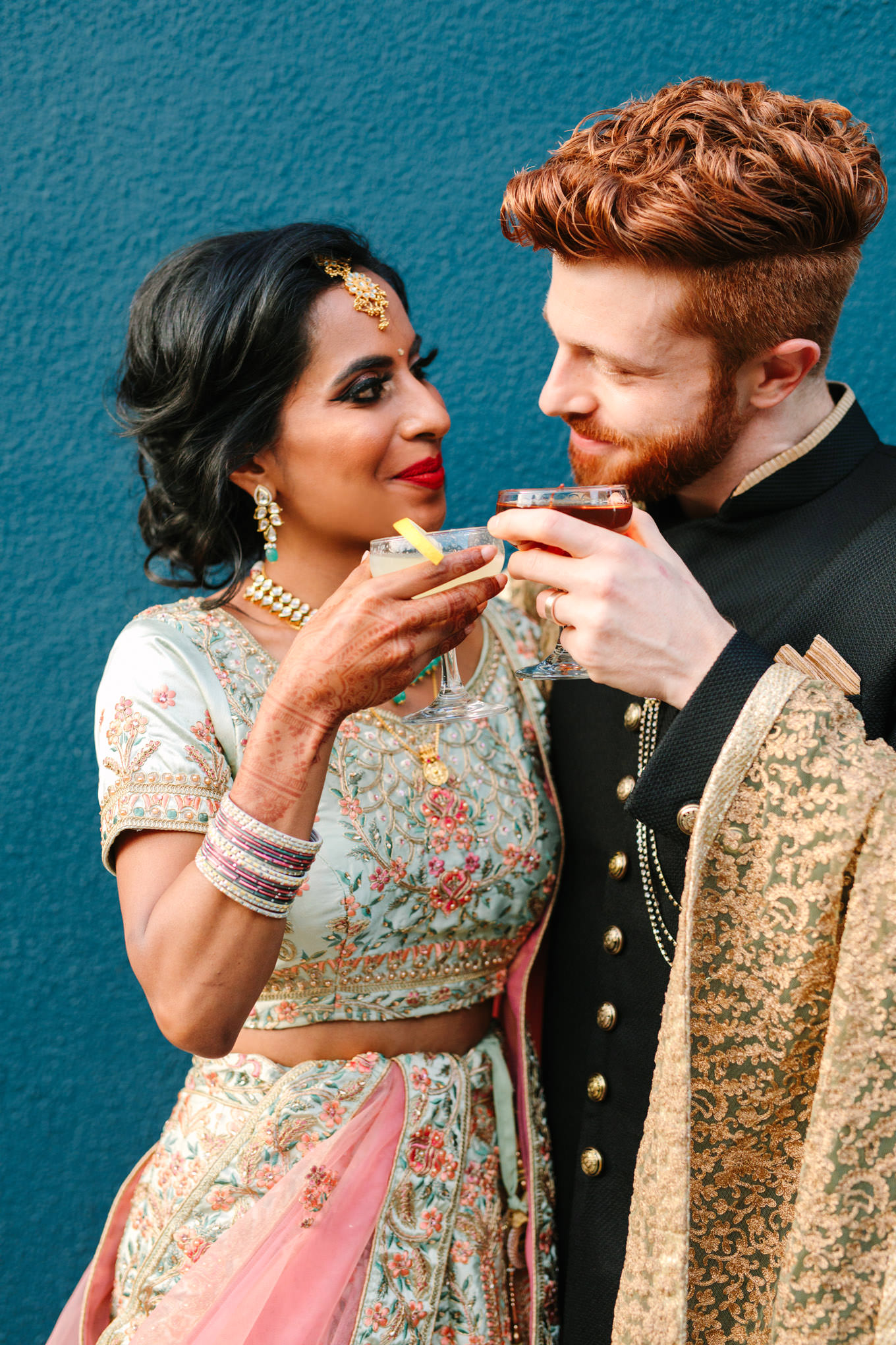 Bride and groom sipping cocktails. Two Disney artists create a unique and colorful Indian Fusion wedding at The Fig House Los Angeles, featured on Green Wedding Shoes. | Colorful and elevated wedding inspiration for fun-loving couples in Southern California | #indianwedding #indianfusionwedding #thefighouse #losangeleswedding   Source: Mary Costa Photography | Los Angeles