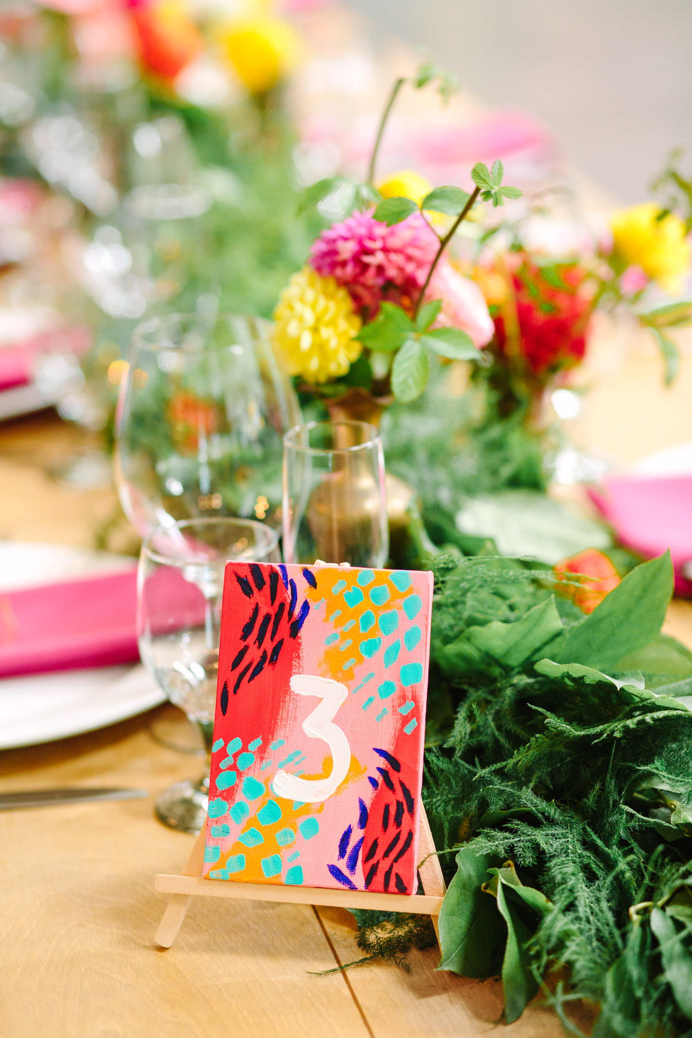 Hand-painted table number. Two Disney artists create a unique and colorful Indian Fusion wedding at The Fig House Los Angeles, featured on Green Wedding Shoes. | Colorful and elevated wedding inspiration for fun-loving couples in Southern California | #indianwedding #indianfusionwedding #thefighouse #losangeleswedding   Source: Mary Costa Photography | Los Angeles