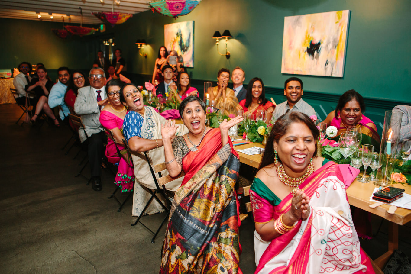Guests react to surprise Bollywood dance at wedding reception. Two Disney artists create a unique and colorful Indian Fusion wedding at The Fig House Los Angeles, featured on Green Wedding Shoes. | Colorful and elevated wedding inspiration for fun-loving couples in Southern California | #indianwedding #indianfusionwedding #thefighouse #losangeleswedding   Source: Mary Costa Photography | Los Angeles