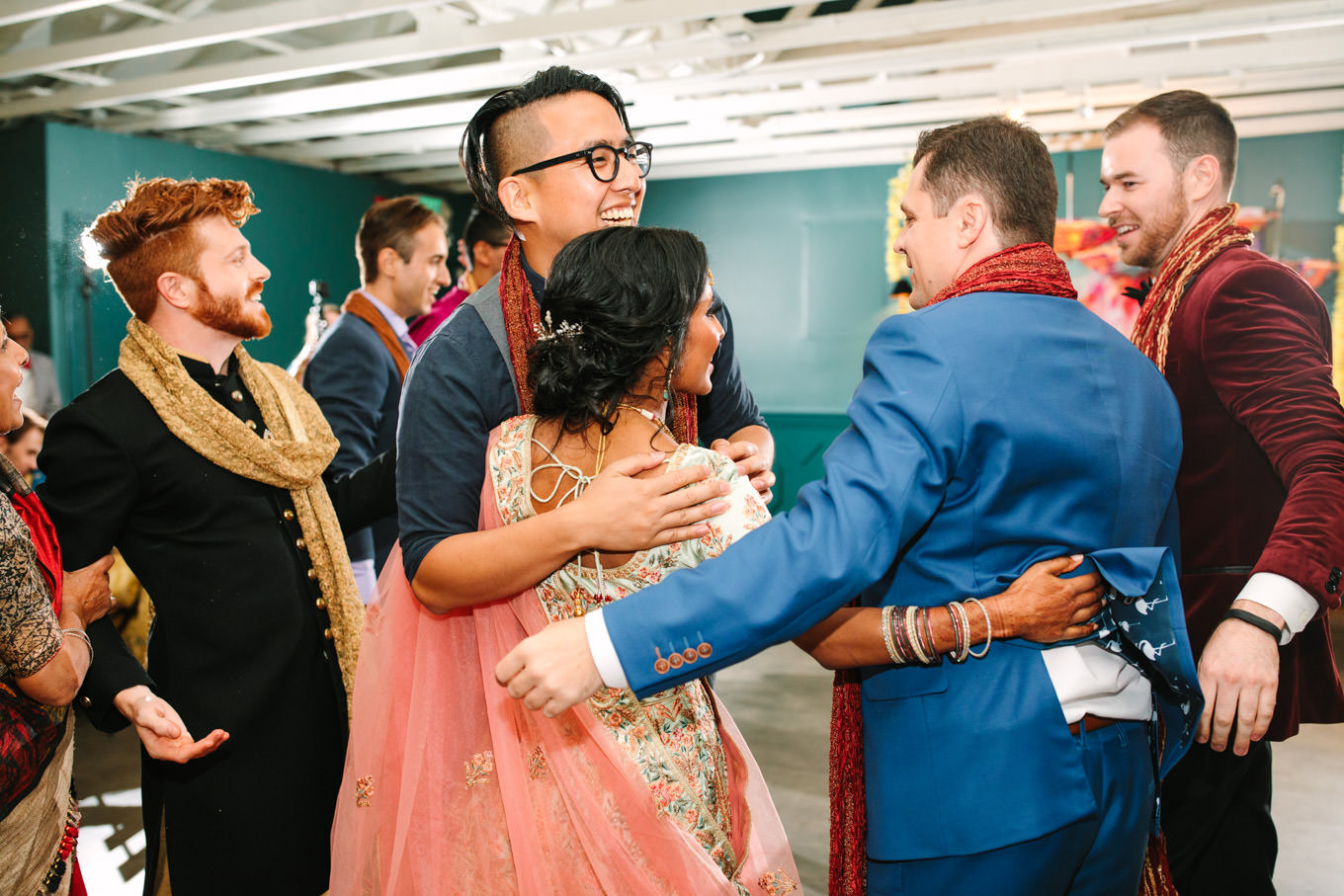 Bride hugging guests. Two Disney artists create a unique and colorful Indian Fusion wedding at The Fig House Los Angeles, featured on Green Wedding Shoes. | Colorful and elevated wedding inspiration for fun-loving couples in Southern California | #indianwedding #indianfusionwedding #thefighouse #losangeleswedding   Source: Mary Costa Photography | Los Angeles