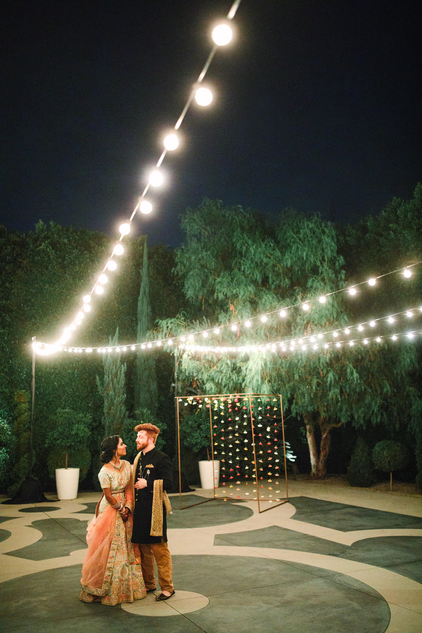 Bride and groom outside of Fig House at night. Two Disney artists create a unique and colorful Indian Fusion wedding at The Fig House Los Angeles, featured on Green Wedding Shoes. | Colorful and elevated wedding inspiration for fun-loving couples in Southern California | #indianwedding #indianfusionwedding #thefighouse #losangeleswedding   Source: Mary Costa Photography | Los Angeles