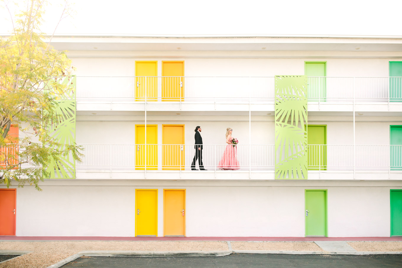 Couple walking at Saguaro Hotel. Modern vintage-inspired Palm Springs engagement session with a 1960s pink Cadillac, retro clothing, and flowers by Shindig Chic. | Colorful and elevated wedding inspiration for fun-loving couples in Southern California | #engagementsession #PalmSpringsengagement #vintageweddingdress #floralcar #pinkcar   Source: Mary Costa Photography | Los Angeles