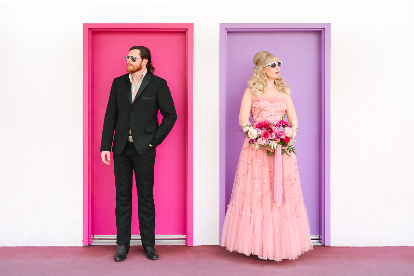 Colorful couple at Saguaro Hotel. Modern vintage-inspired Palm Springs engagement session with a 1960s pink Cadillac, retro clothing, and flowers by Shindig Chic. | Colorful and elevated wedding inspiration for fun-loving couples in Southern California | #engagementsession #PalmSpringsengagement #vintageweddingdress #floralcar #pinkcar   Source: Mary Costa Photography | Los Angeles