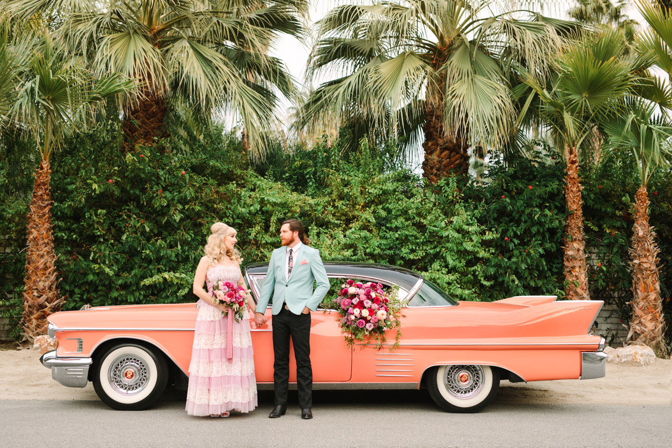 Exterior of Casa de Monte Vista. Modern vintage-inspired Palm Springs engagement session with a 1960s pink Cadillac, retro clothing, and flowers by Shindig Chic. | Colorful and elevated wedding inspiration for fun-loving couples in Southern California | #engagementsession #PalmSpringsengagement #vintageweddingdress #floralcar #pinkcar   Source: Mary Costa Photography | Los Angeles