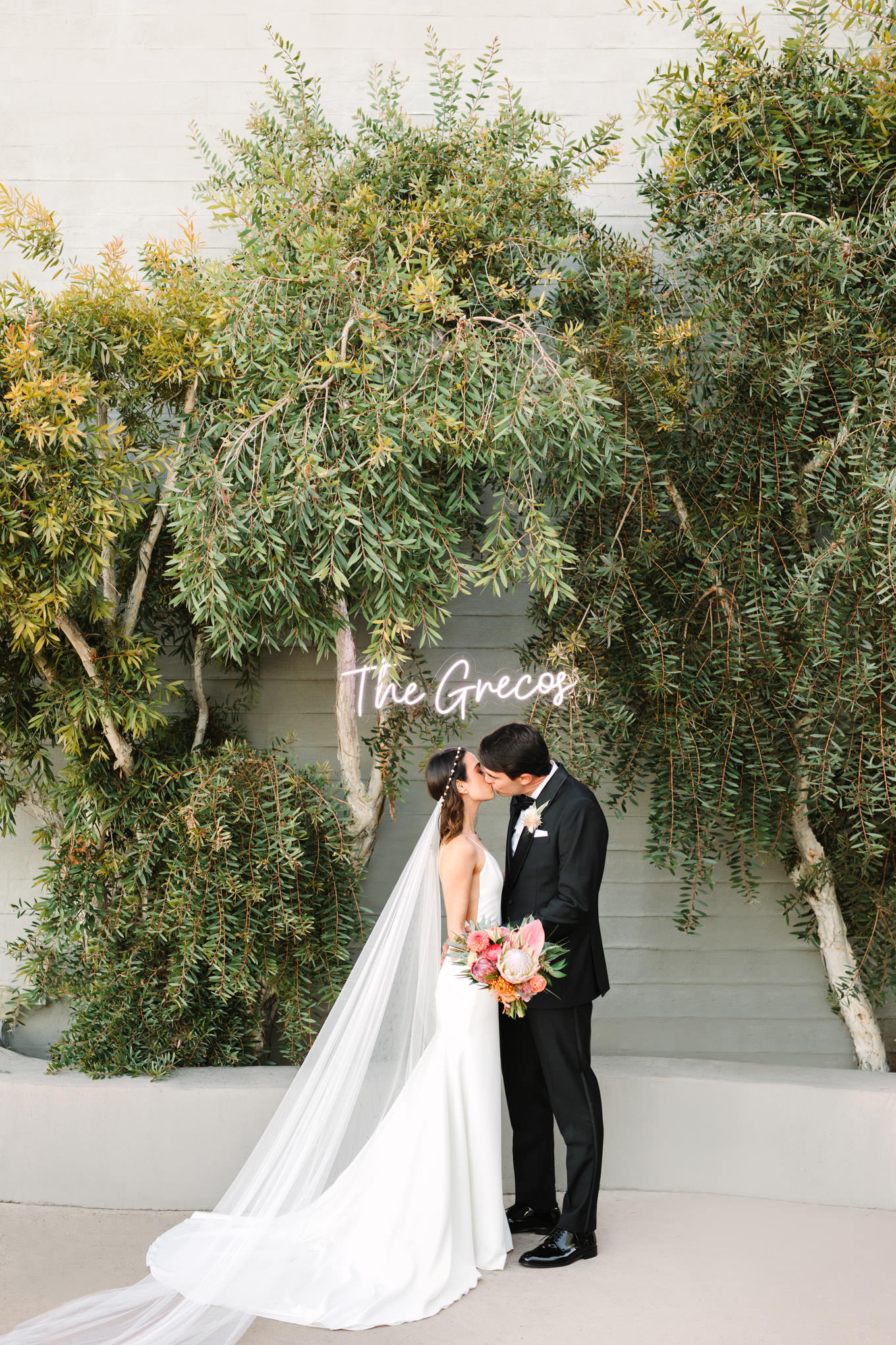 Bride and groom kissing in front of custom neon sign | Engagement, elopement, and wedding photography roundup of Mary Costa’s favorite images from 2020 | Colorful and elevated photography for fun-loving couples in Southern California | #2020wedding #elopement #weddingphoto #weddingphotography #microwedding   Source: Mary Costa Photography | Los Angeles