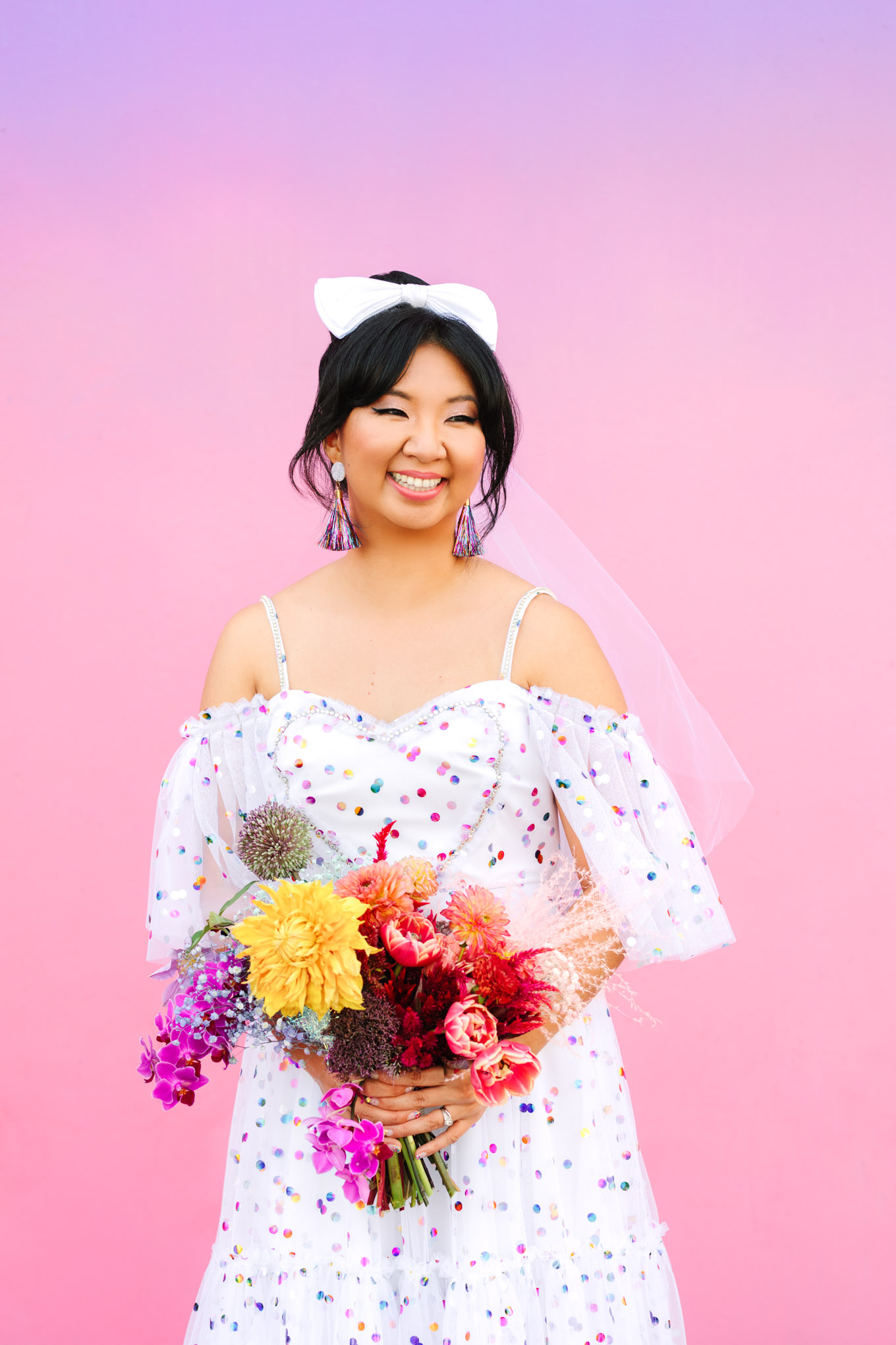 Bride in confetti dress with rainbow bouquet and hair bow | Engagement, elopement, and wedding photography roundup of Mary Costa’s favorite images from 2020 | Colorful and elevated photography for fun-loving couples in Southern California | #2020wedding #elopement #weddingphoto #weddingphotography #microwedding   Source: Mary Costa Photography | Los Angeles