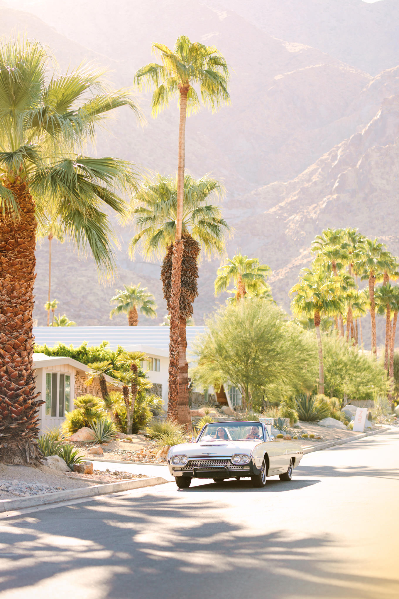 Bride and groom driving classic car during Palm Springs elopement | Engagement, elopement, and wedding photography roundup of Mary Costa’s favorite images from 2020 | Colorful and elevated photography for fun-loving couples in Southern California | #2020wedding #elopement #weddingphoto #weddingphotography #microwedding   Source: Mary Costa Photography | Los Angeles