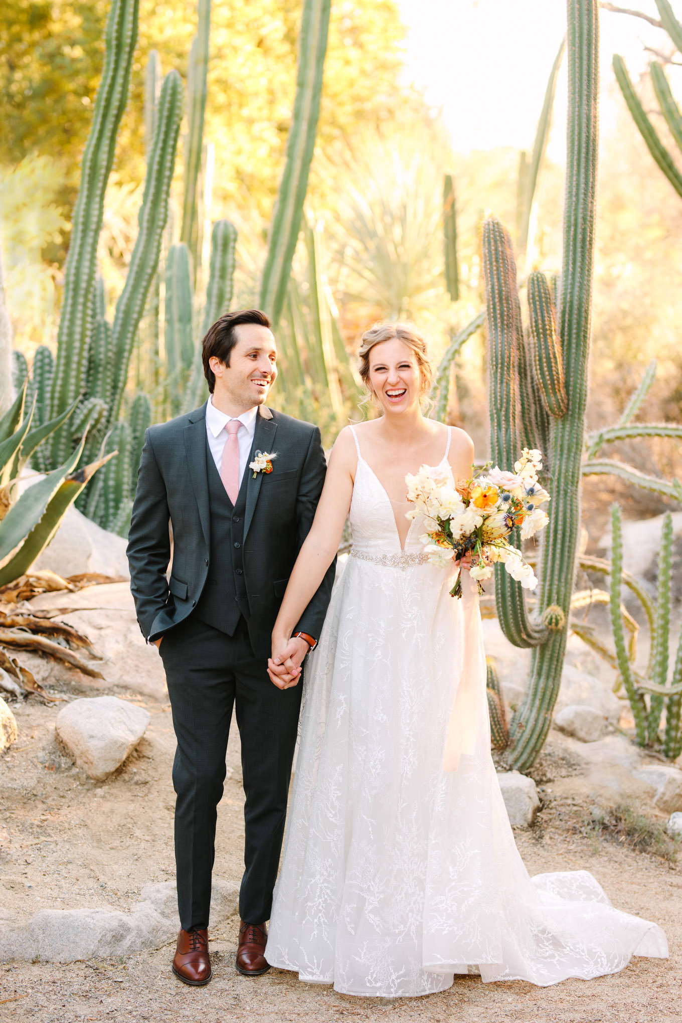 Bride and groom laughing in cactus garden | Living Desert Zoo & Gardens wedding with unique details | Elevated and colorful wedding photography for fun-loving couples in Southern California |  #PalmSprings #palmspringsphotographer #gardenwedding #palmspringswedding  Source: Mary Costa Photography | Los Angeles wedding photographer