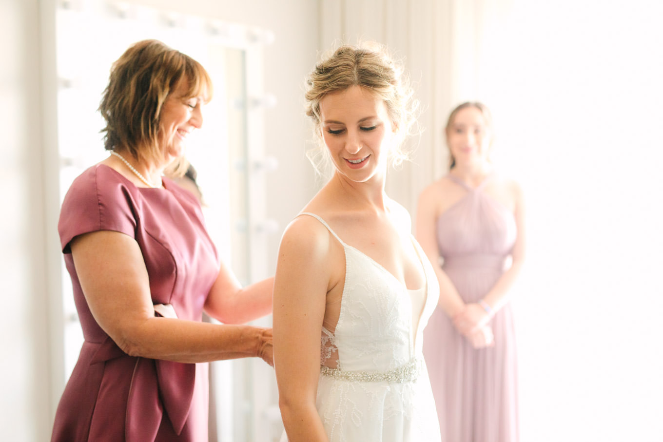 Mother of the bride helping bride get dressed | Living Desert Zoo & Gardens wedding with unique details | Elevated and colorful wedding photography for fun-loving couples in Southern California |  #PalmSprings #palmspringsphotographer #gardenwedding #palmspringswedding  Source: Mary Costa Photography | Los Angeles wedding photographer 