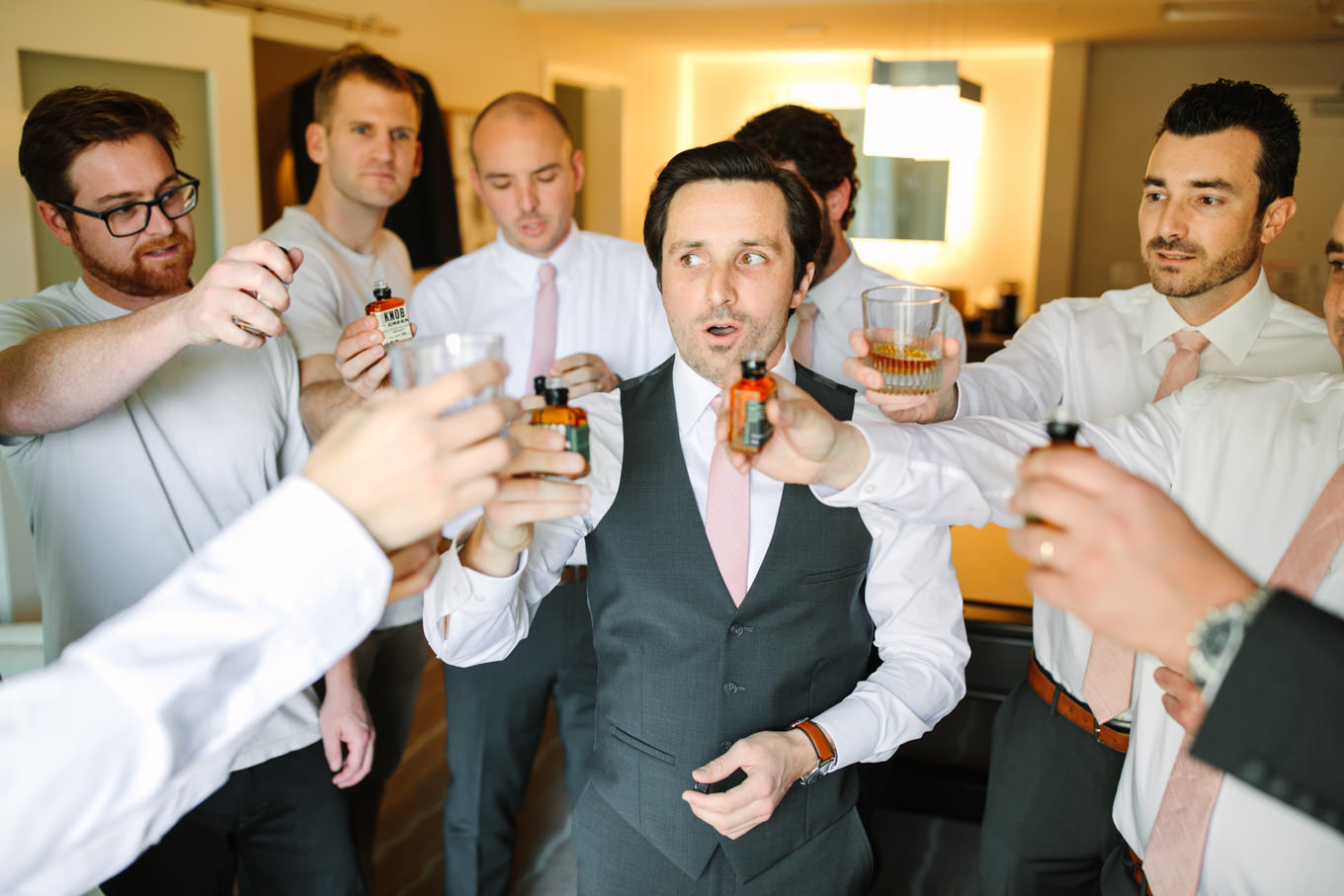 Groomsmen toasting shots of whiskey | Living Desert Zoo & Gardens wedding with unique details | Elevated and colorful wedding photography for fun-loving couples in Southern California |  #PalmSprings #palmspringsphotographer #gardenwedding #palmspringswedding  Source: Mary Costa Photography | Los Angeles wedding photographer 
