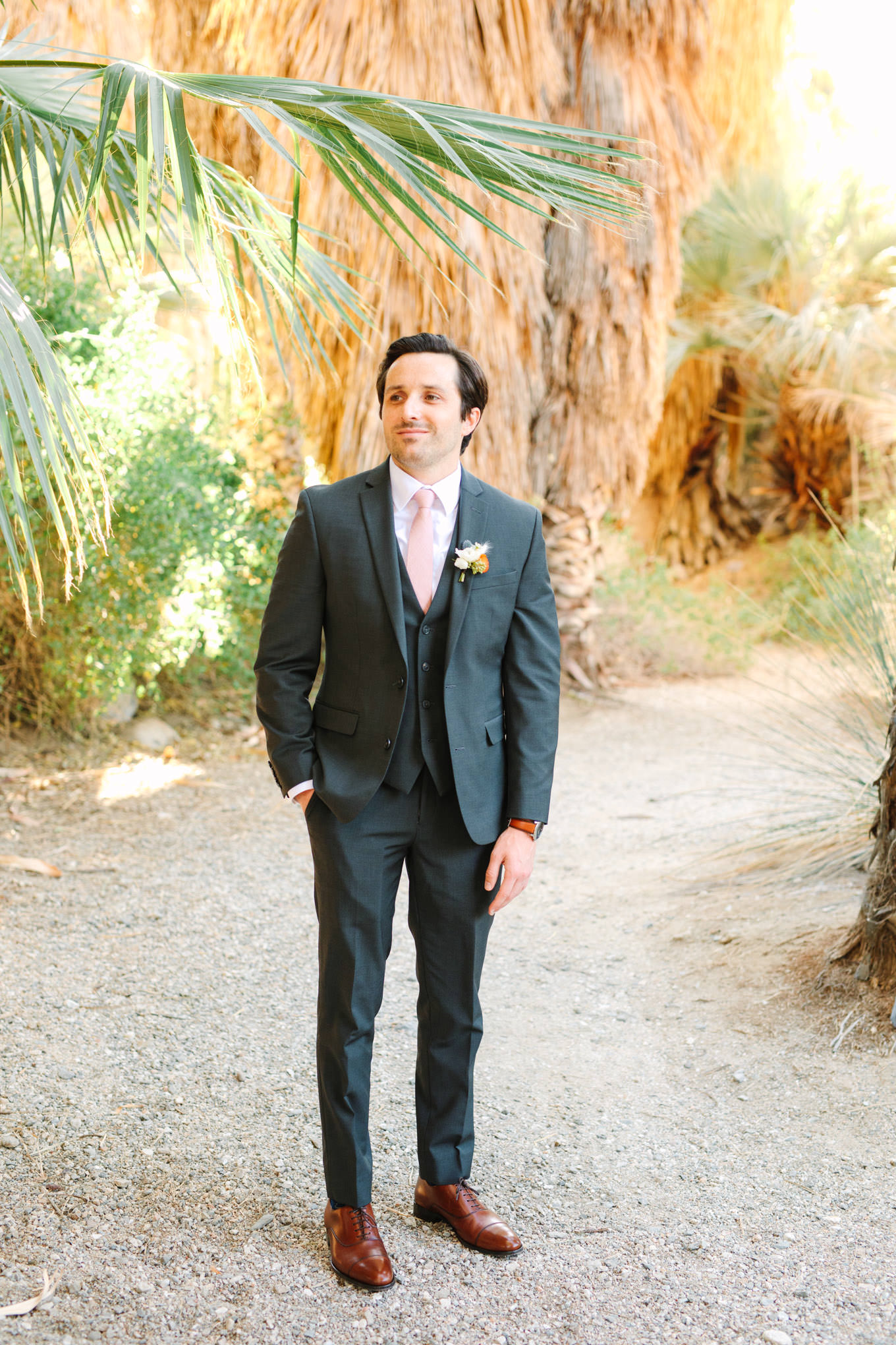 Groom in dark gray suit with blush pink tie | Living Desert Zoo & Gardens wedding with unique details | Elevated and colorful wedding photography for fun-loving couples in Southern California |  #PalmSprings #palmspringsphotographer #gardenwedding #palmspringswedding  Source: Mary Costa Photography | Los Angeles wedding photographer 