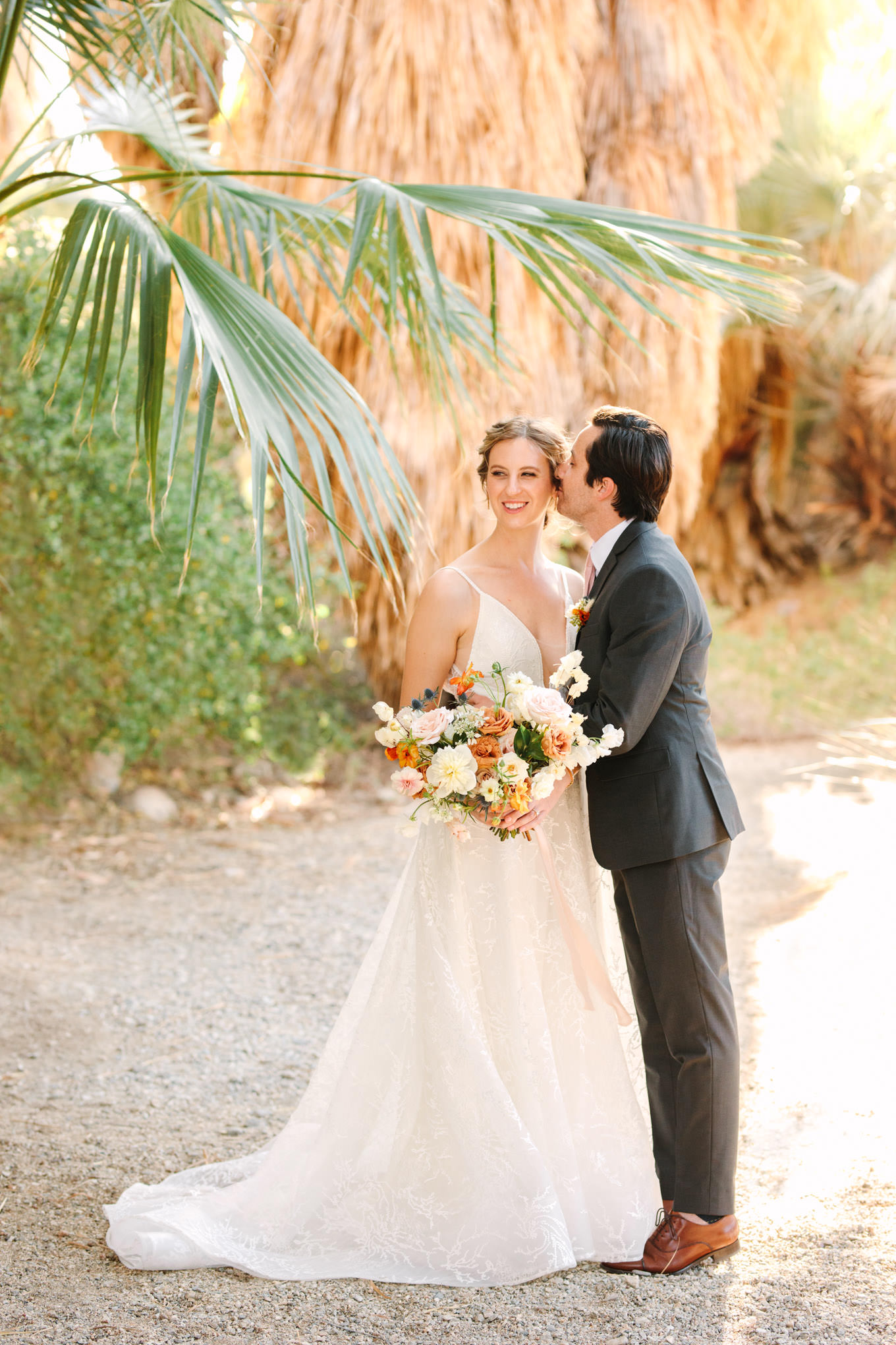 Bride and groom kissing in palm garden | Living Desert Zoo & Gardens wedding with unique details | Elevated and colorful wedding photography for fun-loving couples in Southern California |  #PalmSprings #palmspringsphotographer #gardenwedding #palmspringswedding  Source: Mary Costa Photography | Los Angeles wedding photographer 