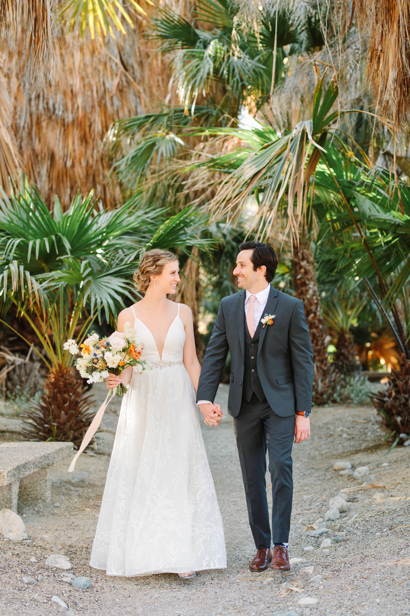 Wedding portrait of bride and groom walking in palm garden | Living Desert Zoo & Gardens wedding with unique details | Elevated and colorful wedding photography for fun-loving couples in Southern California |  #PalmSprings #palmspringsphotographer #gardenwedding #palmspringswedding  Source: Mary Costa Photography | Los Angeles wedding photographer 