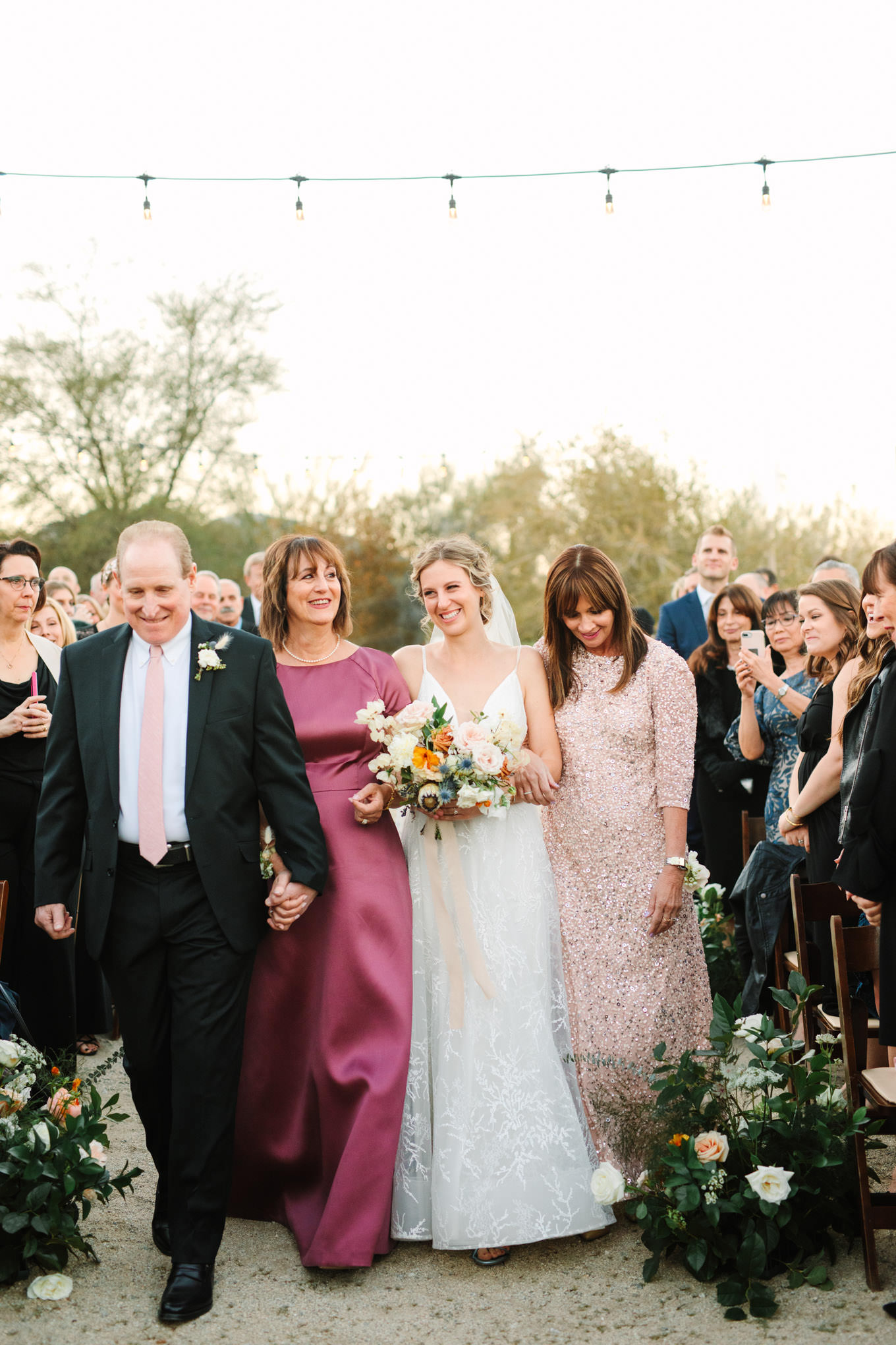 Bride being escorted down the aisle | Living Desert Zoo & Gardens wedding with unique details | Elevated and colorful wedding photography for fun-loving couples in Southern California |  #PalmSprings #palmspringsphotographer #gardenwedding #palmspringswedding  Source: Mary Costa Photography | Los Angeles wedding photographer 