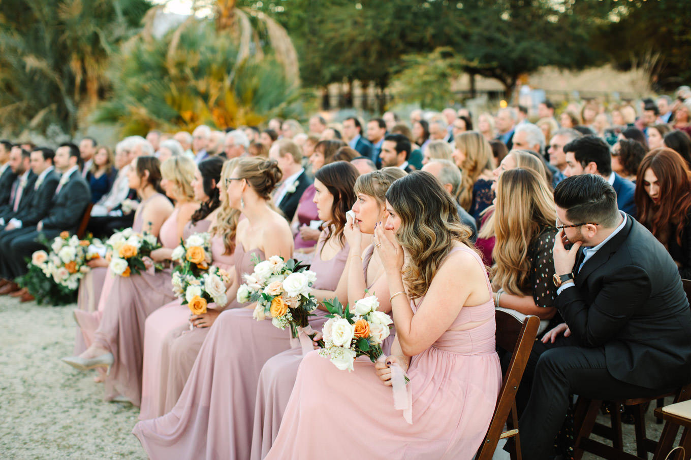 Candid of bridesmaids during wedding ceremony | Living Desert Zoo & Gardens wedding with unique details | Elevated and colorful wedding photography for fun-loving couples in Southern California |  #PalmSprings #palmspringsphotographer #gardenwedding #palmspringswedding  Source: Mary Costa Photography | Los Angeles wedding photographer 