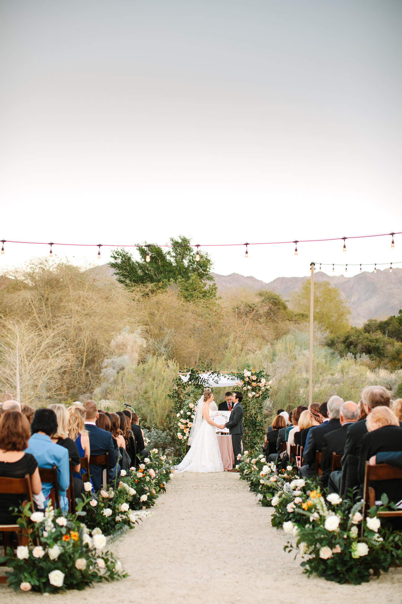 Wide shot of wedding ceremony | Living Desert Zoo & Gardens wedding with unique details | Elevated and colorful wedding photography for fun-loving couples in Southern California |  #PalmSprings #palmspringsphotographer #gardenwedding #palmspringswedding  Source: Mary Costa Photography | Los Angeles wedding photographer 