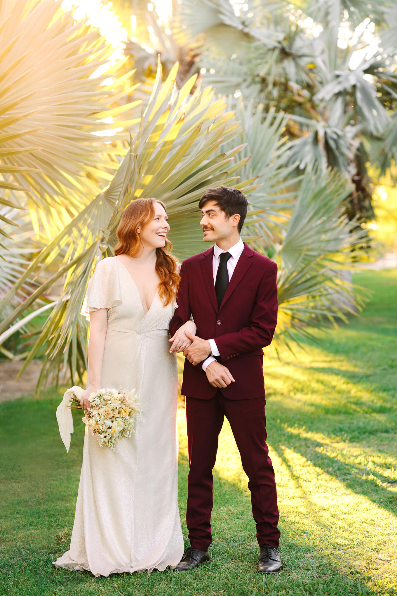Bride and groom among sunny palm trees | Los Angeles Arboretum Elopement | Colorful and elevated wedding photography for fun-loving couples in Southern California | #LosAngelesElopement #elopement #LAarboretum #LAskyline #elopementphotos   Source: Mary Costa Photography | Los Angeles