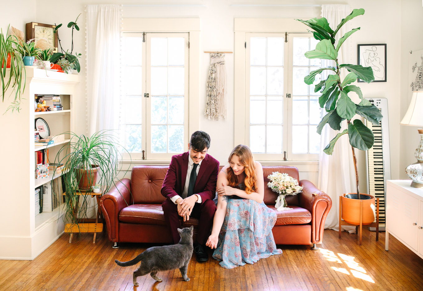 Couple in boho Los Angeles living room on a couch with their cat | Los Angeles Arboretum Elopement | Colorful and elevated wedding photography for fun-loving couples in Southern California | #LosAngelesElopement #elopement #LAarboretum #LAskyline #elopementphotos   Source: Mary Costa Photography | Los Angeles 