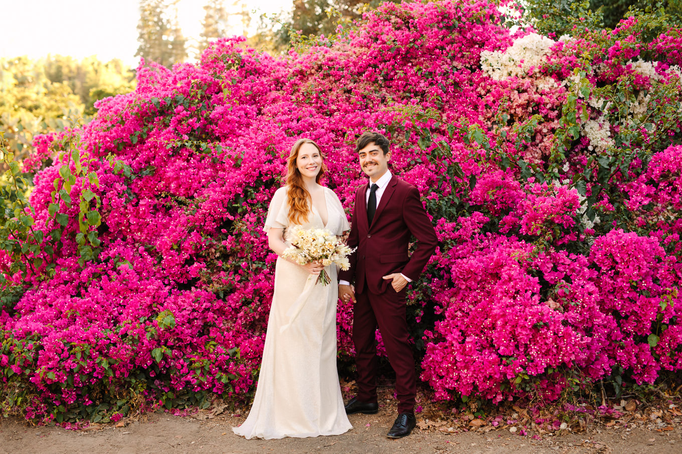 Bride and groom in front of lush bougainvillea | Los Angeles Arboretum Elopement | Colorful and elevated wedding photography for fun-loving couples in Southern California | #LosAngelesElopement #elopement #LAarboretum #LAskyline #elopementphotos   Source: Mary Costa Photography | Los Angeles