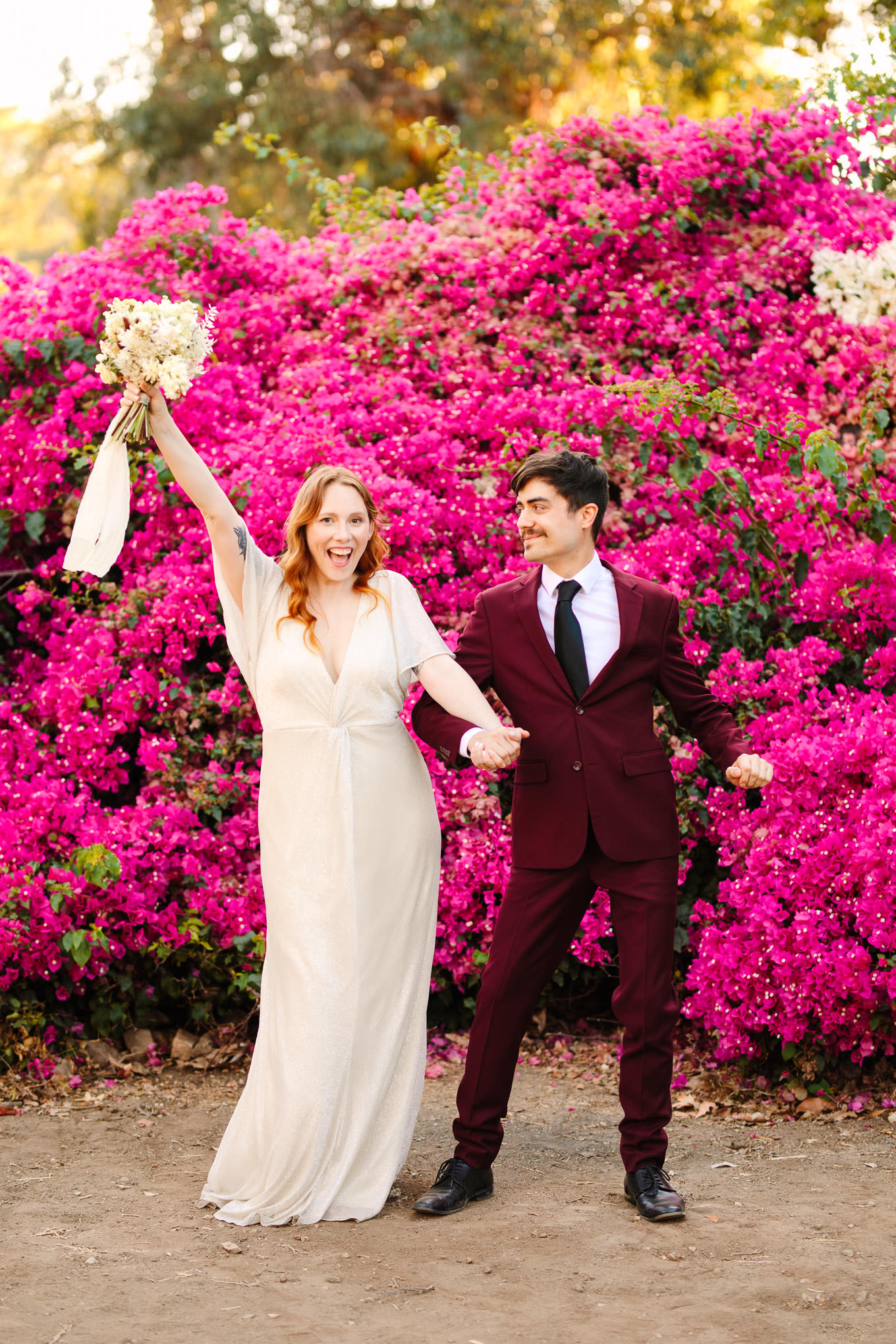 Bride and groom dancing in front of bougainvillea | Los Angeles Arboretum Elopement | Colorful and elevated wedding photography for fun-loving couples in Southern California | #LosAngelesElopement #elopement #LAarboretum #LAskyline #elopementphotos   Source: Mary Costa Photography | Los Angeles