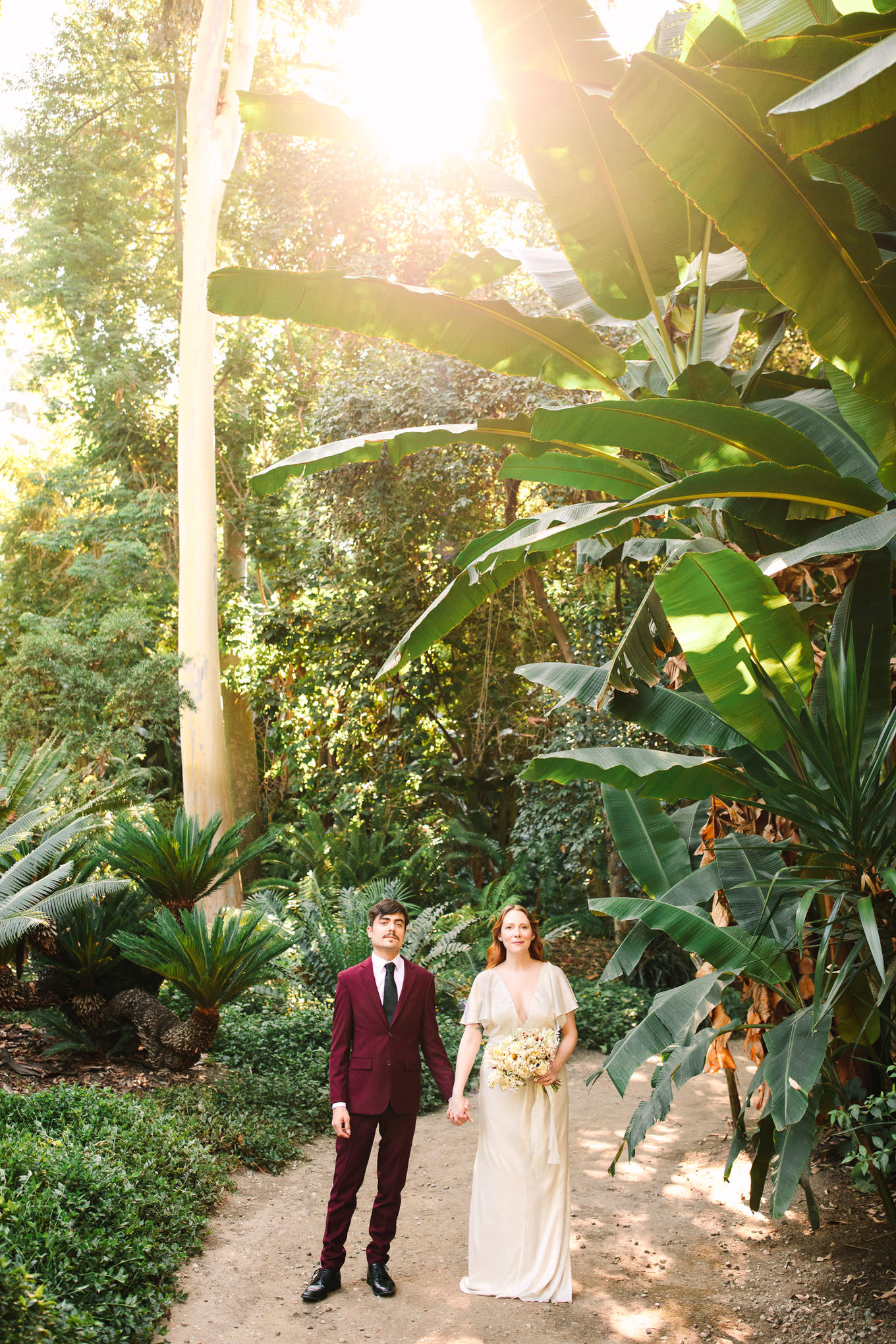 Bride and groom standing in prehistoric garden | Los Angeles Arboretum Elopement | Colorful and elevated wedding photography for fun-loving couples in Southern California | #LosAngelesElopement #elopement #LAarboretum #LAskyline #elopementphotos   Source: Mary Costa Photography | Los Angeles