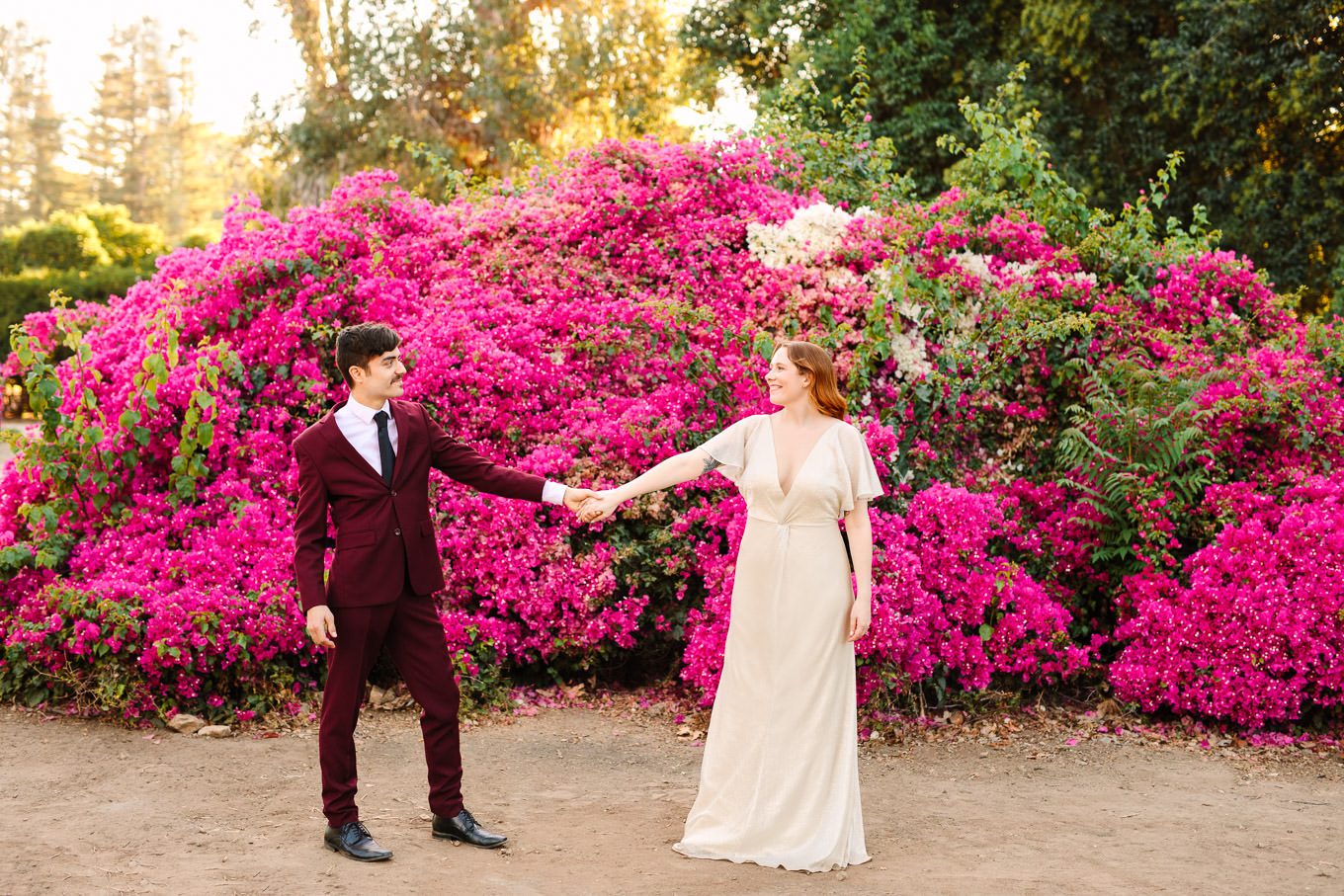 Bride and groom in front of lush magenta bougainvillea | Los Angeles Arboretum Elopement | Colorful and elevated wedding photography for fun-loving couples in Southern California | #LosAngelesElopement #elopement #LAarboretum #LAskyline #elopementphotos   Source: Mary Costa Photography | Los Angeles