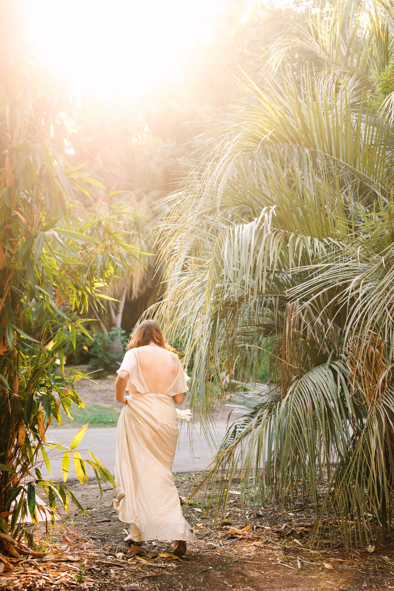 Bride walking among palm trees | Los Angeles Arboretum Elopement | Colorful and elevated wedding photography for fun-loving couples in Southern California | #LosAngelesElopement #elopement #LAarboretum #LAskyline #elopementphotos   Source: Mary Costa Photography | Los Angeles
