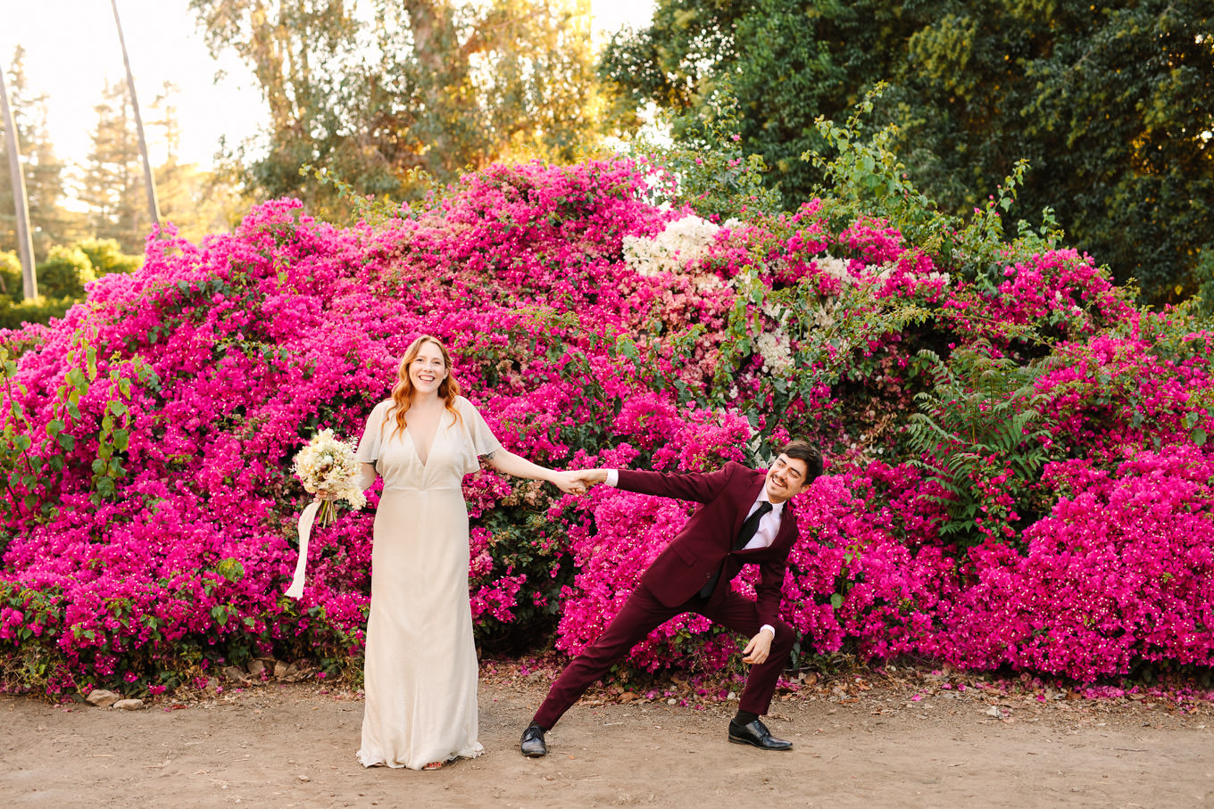 Bride and groom being playful in front of bougainvillea | Los Angeles Arboretum Elopement | Colorful and elevated wedding photography for fun-loving couples in Southern California | #LosAngelesElopement #elopement #LAarboretum #LAskyline #elopementphotos   Source: Mary Costa Photography | Los Angeles